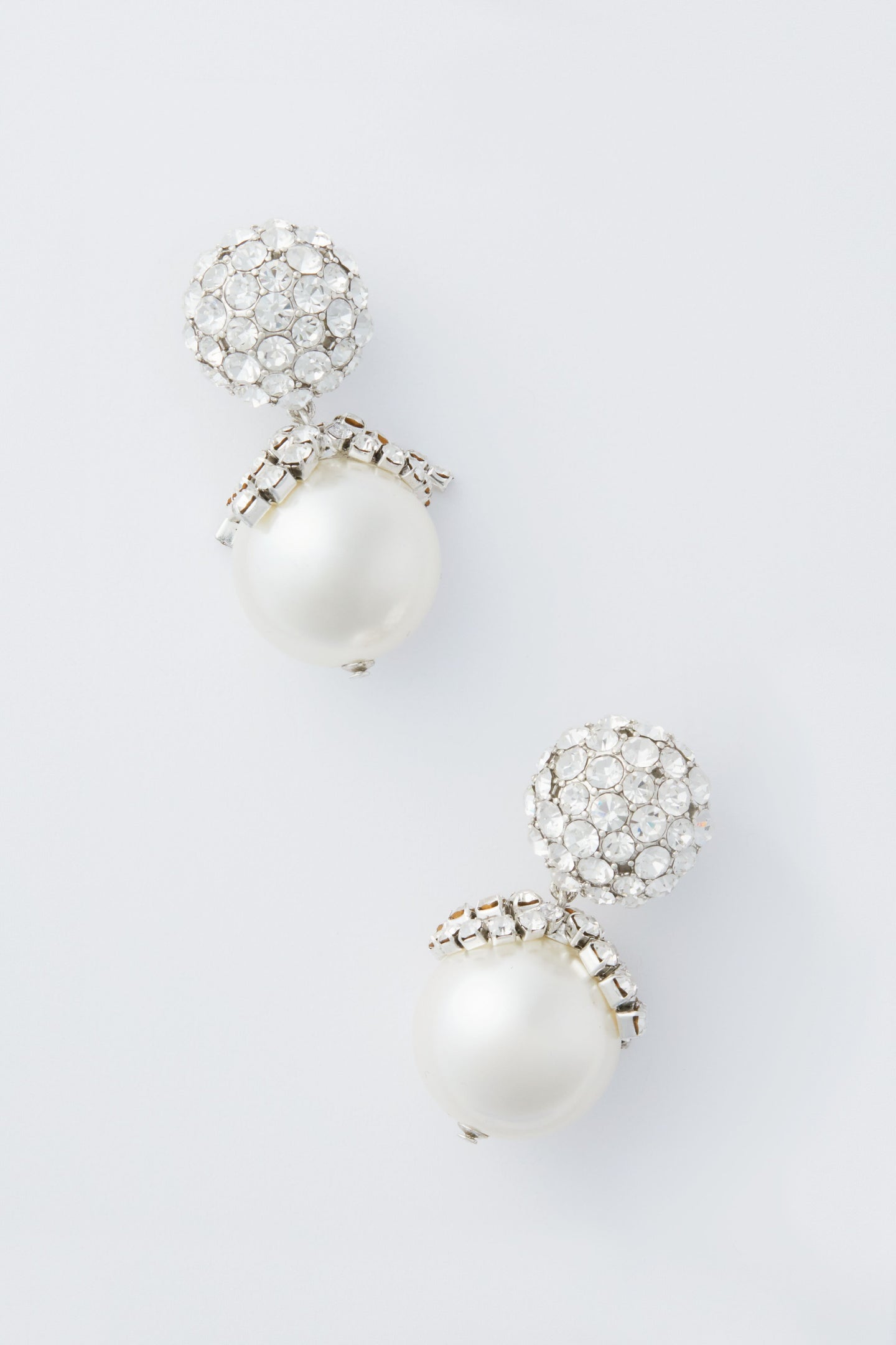 Tuckernuck Jewelry dangle earrings with round white pearls and clusters of clear gemstones add an elegant touch to any outfit.