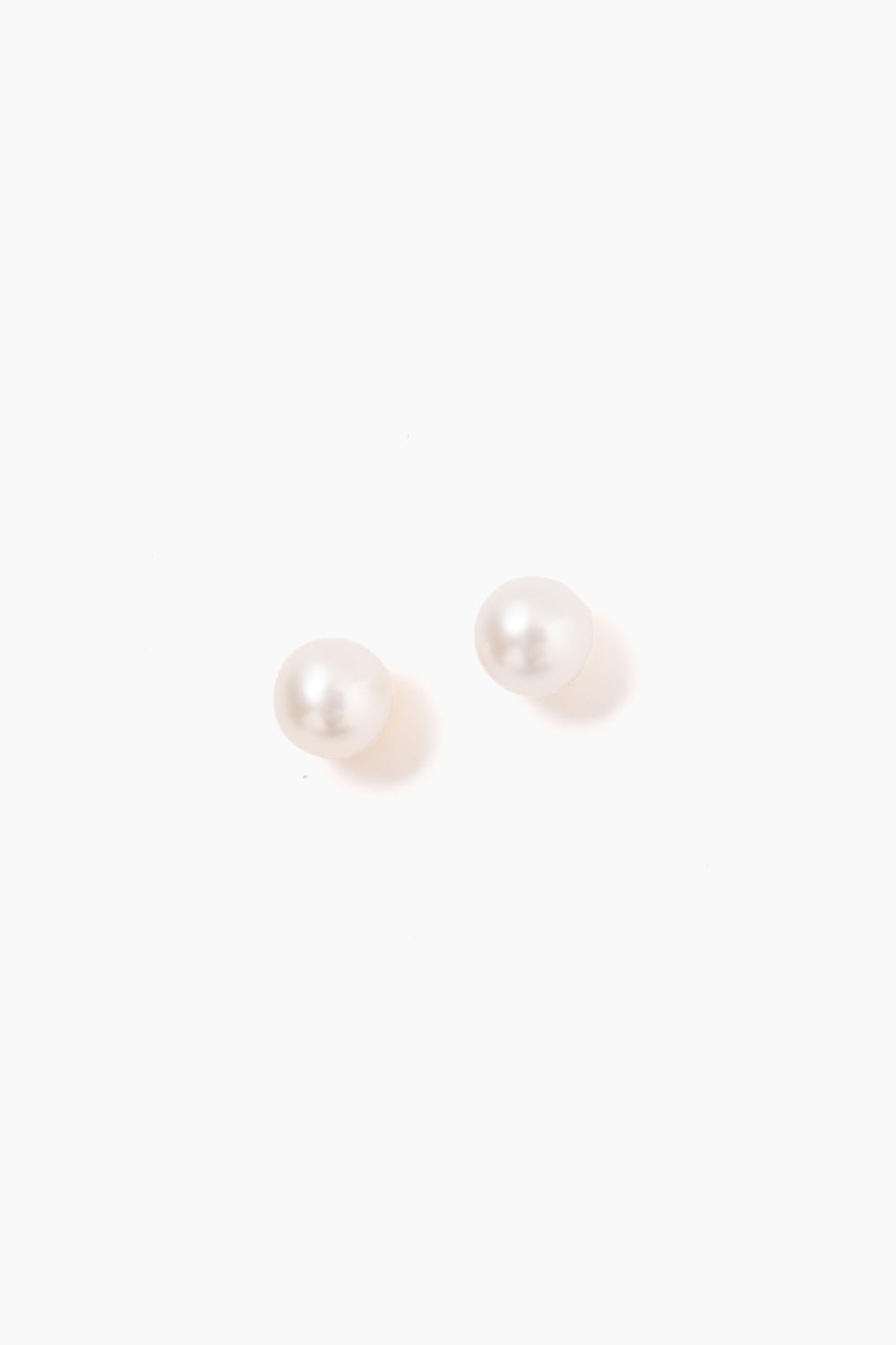 Tuckernuck Jewelry's round white freshwater pearl stud earrings are beautifully crafted and hypoallergenic, perfect for sensitive ears.