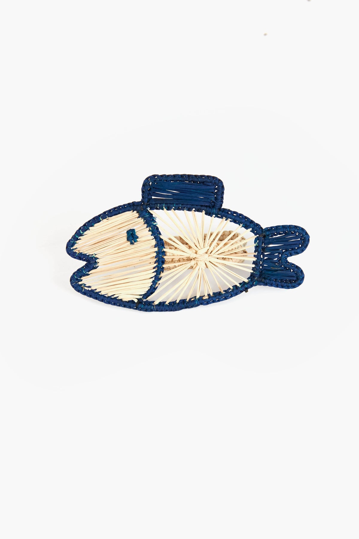 A fish shape outlined with blue thread and a beige crisscross body—this Coro Cora artisan piece showcases the distinct beauty of Colombian Iraca palm homeware accessories.