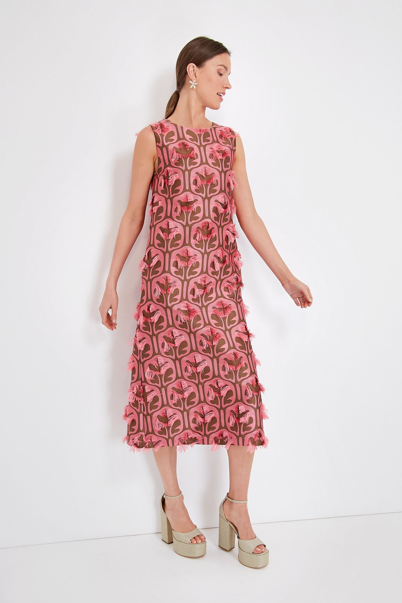 A woman wears a La DoubleJ sleeveless jacquard dress with pink and brown fringe, paired with platform sandals.