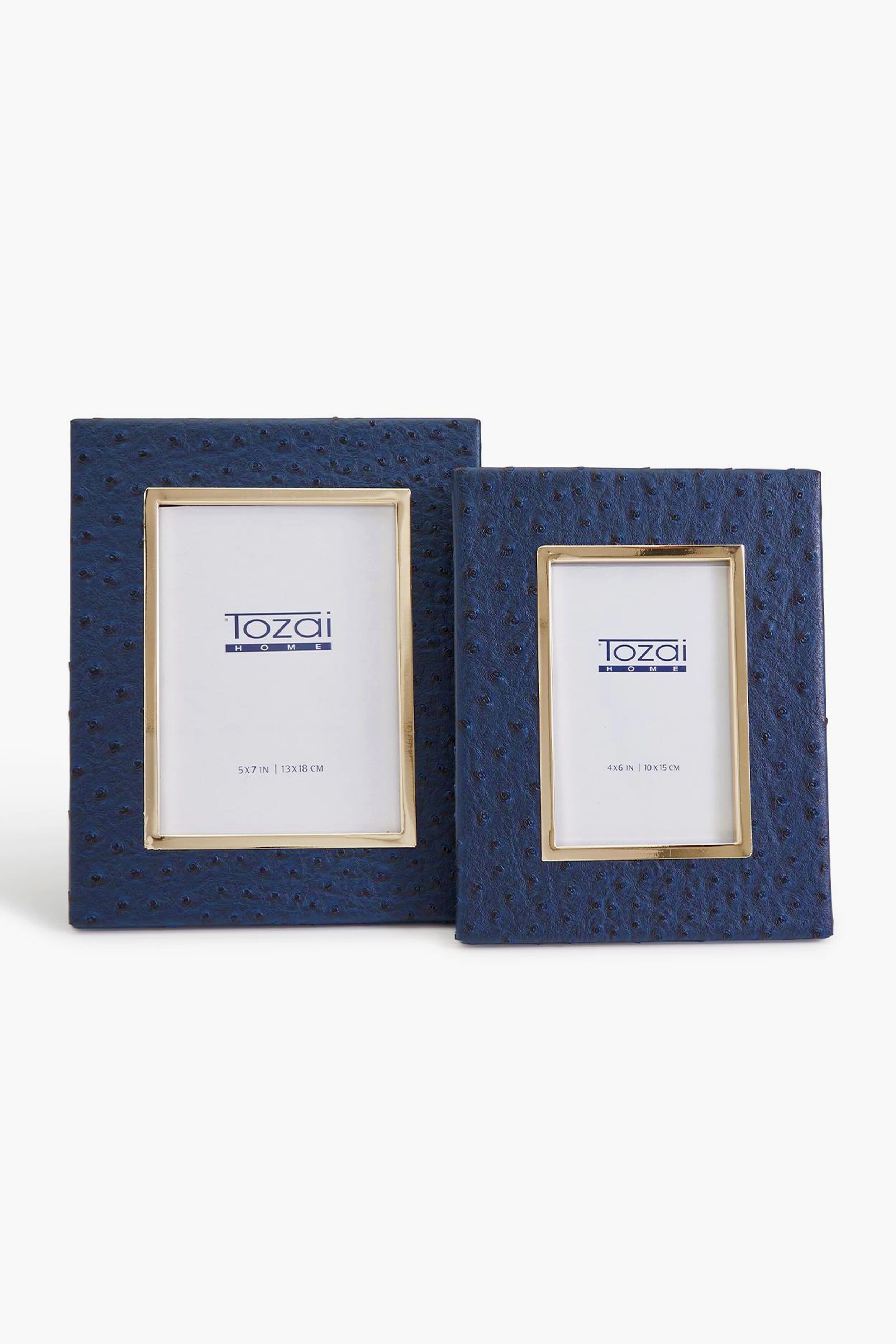 Two's Company presents two navy blue rectangular photo frames in different sizes with an elegant ostrich texture, displayed upright—perfect for stylishly showcasing your memories.
