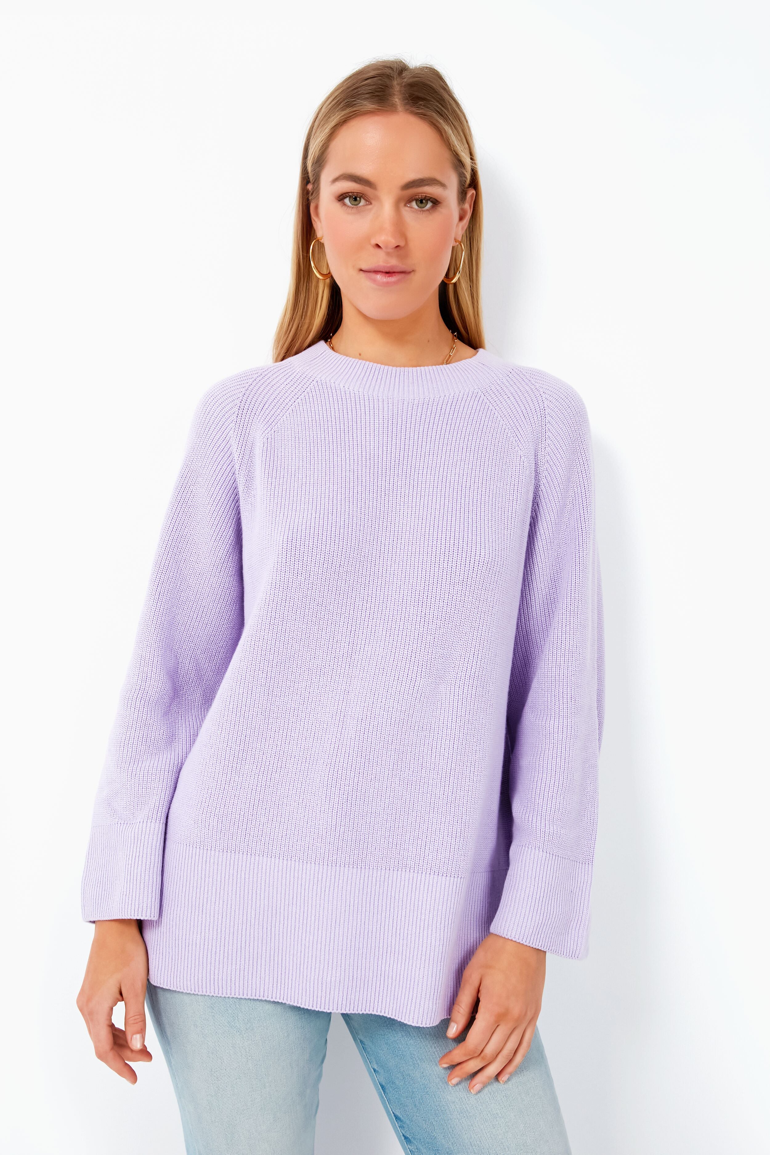 A woman models a loose pastel Barbour sweater and light blue jeans, highlighting the cozy look of the Barbour Iris Barrhead Knit.