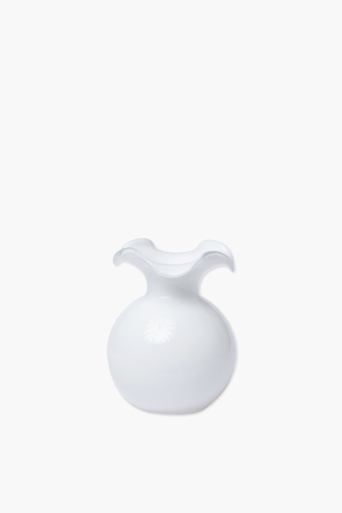 Handcrafted in Italy, the Vietri white glass vase features a round base and a wavy, flared rim for an elegant touch.