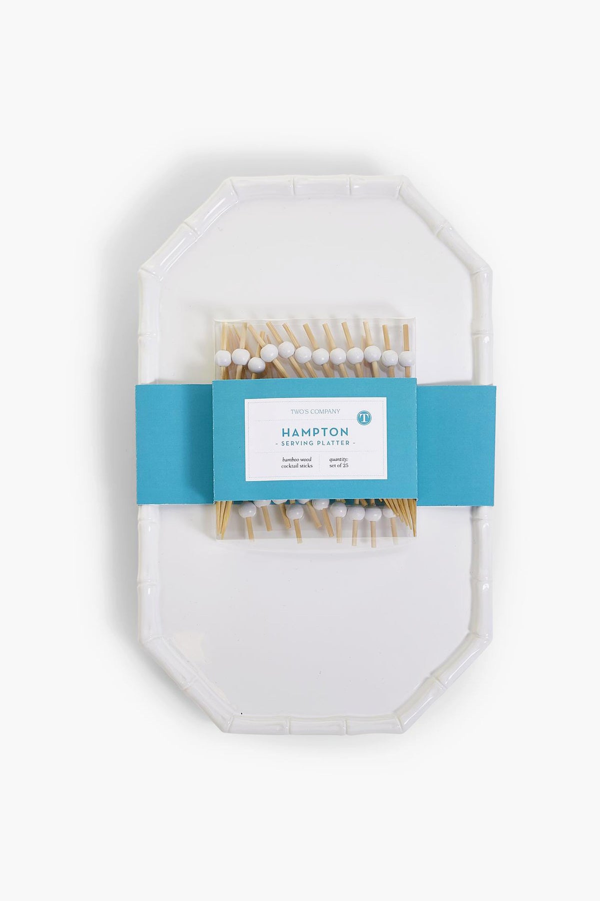 This Two's Company set includes a white chinoiserie serving platter with a faux bamboo-style rim, packaged in a blue paper band and paired with wooden cocktail picks featuring decorative white and blue tops.