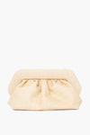 A beige, textured natural raffia clutch purse by Themoire features a structured frame, gathered fabric design, and is elegantly crafted in Italy.