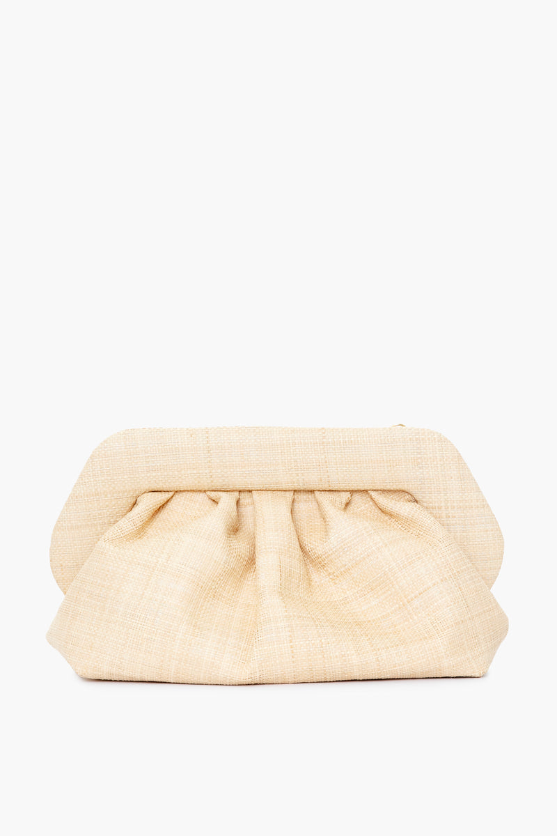 A beige, textured natural raffia clutch purse by Themoire features a structured frame, gathered fabric design, and is elegantly crafted in Italy.