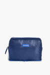 A blue rectangular zippered toiletry bag by Paravel, featuring a small front label—ideal for use as a travel organizer.