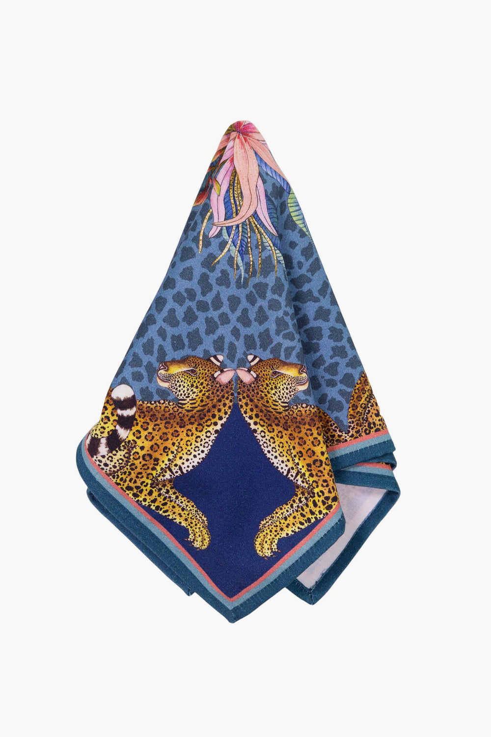 A patterned fabric napkin by Ardmore Design featuring leopards and a bird of paradise flower, folded to display its vibrant design—perfect for adding modern collectible style to your home decor.