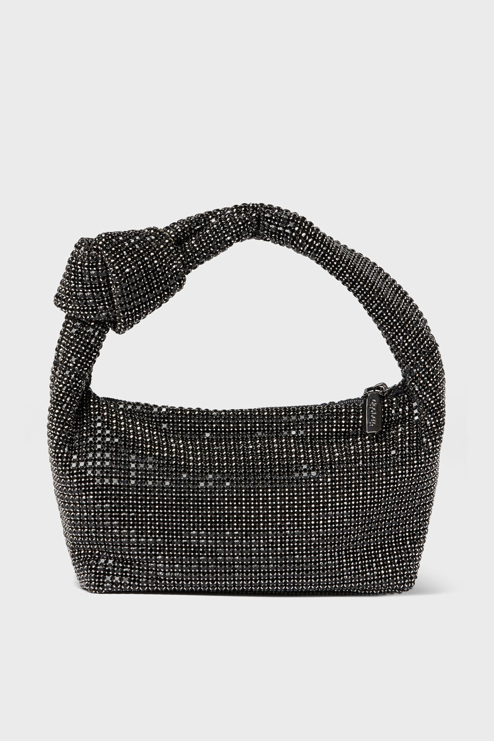 A black, beaded Olga Berg evening bag with a knotted handle and a small rectangular tag—ideal for special occasions.