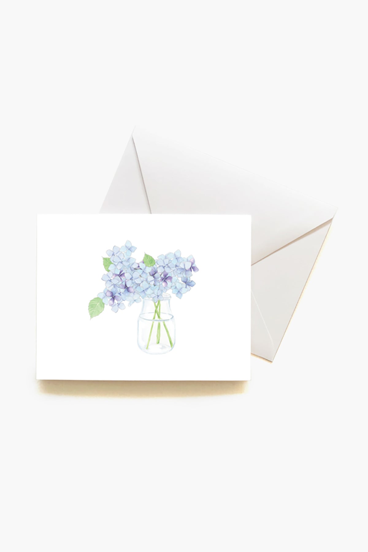 This Sara Fitz greeting card features a watercolor blue hydrangea in a glass jar on a white envelope—perfect for gifting with the Hydrangea Boxed Notes Set or as lovely stationery for any hostess gift.