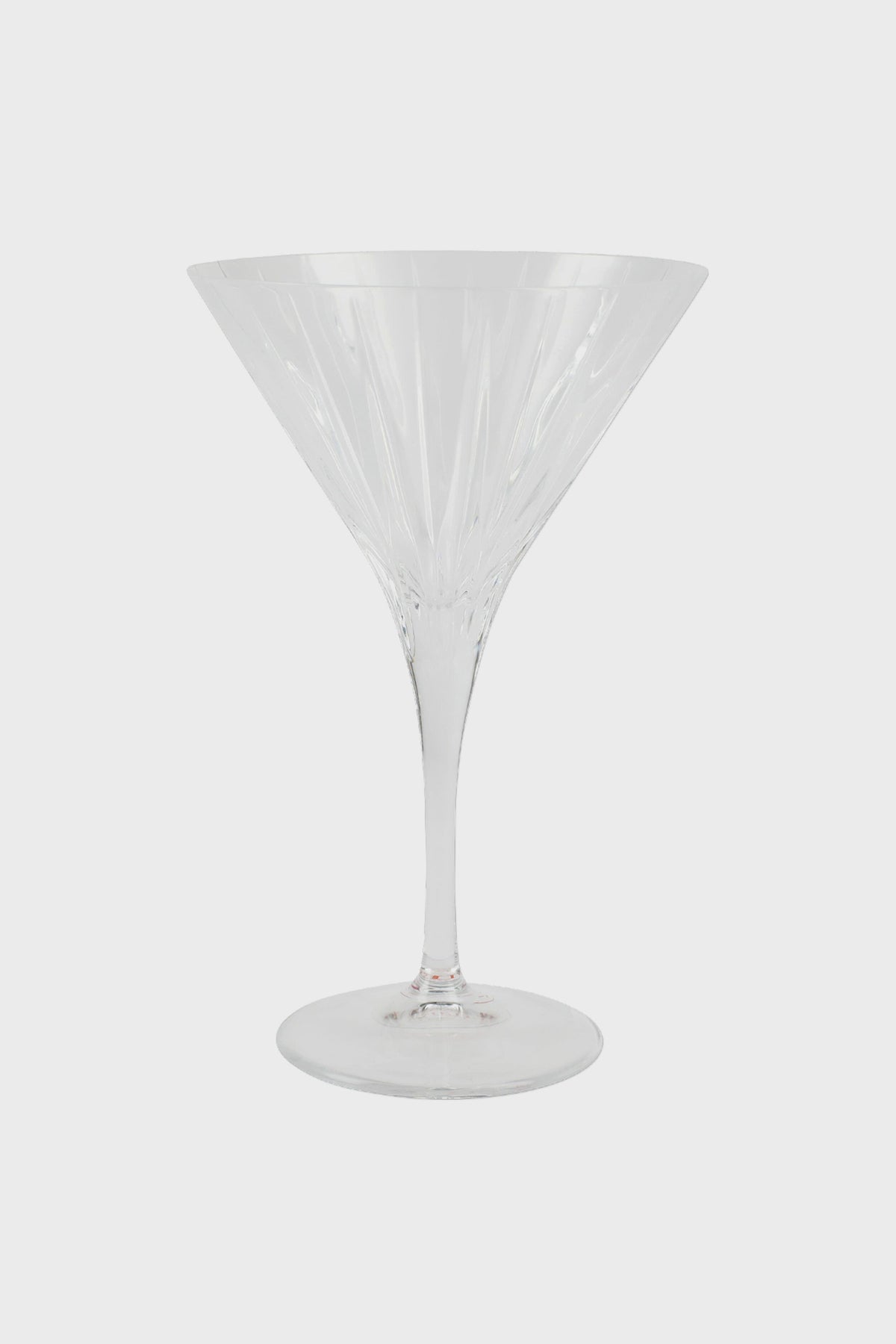 A clear, empty Vietri stemmed martini glass with a wide bowl and long stem, crafted in the style of fine Italian glass.