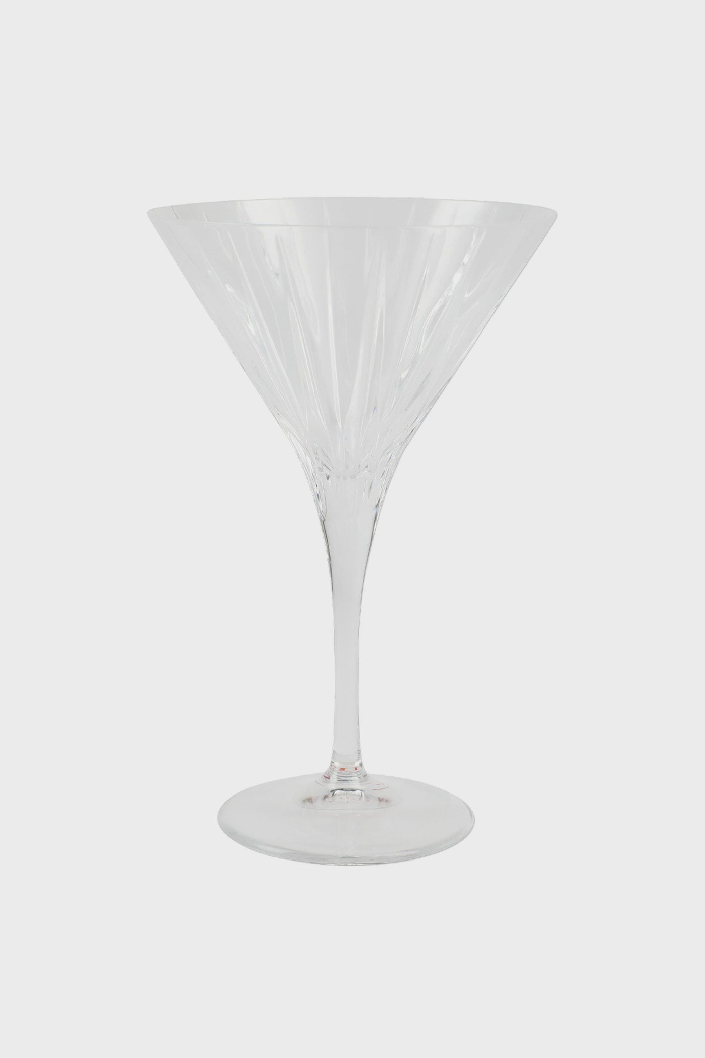 A clear, empty Vietri stemmed martini glass with a wide bowl and long stem, crafted in the style of fine Italian glass.