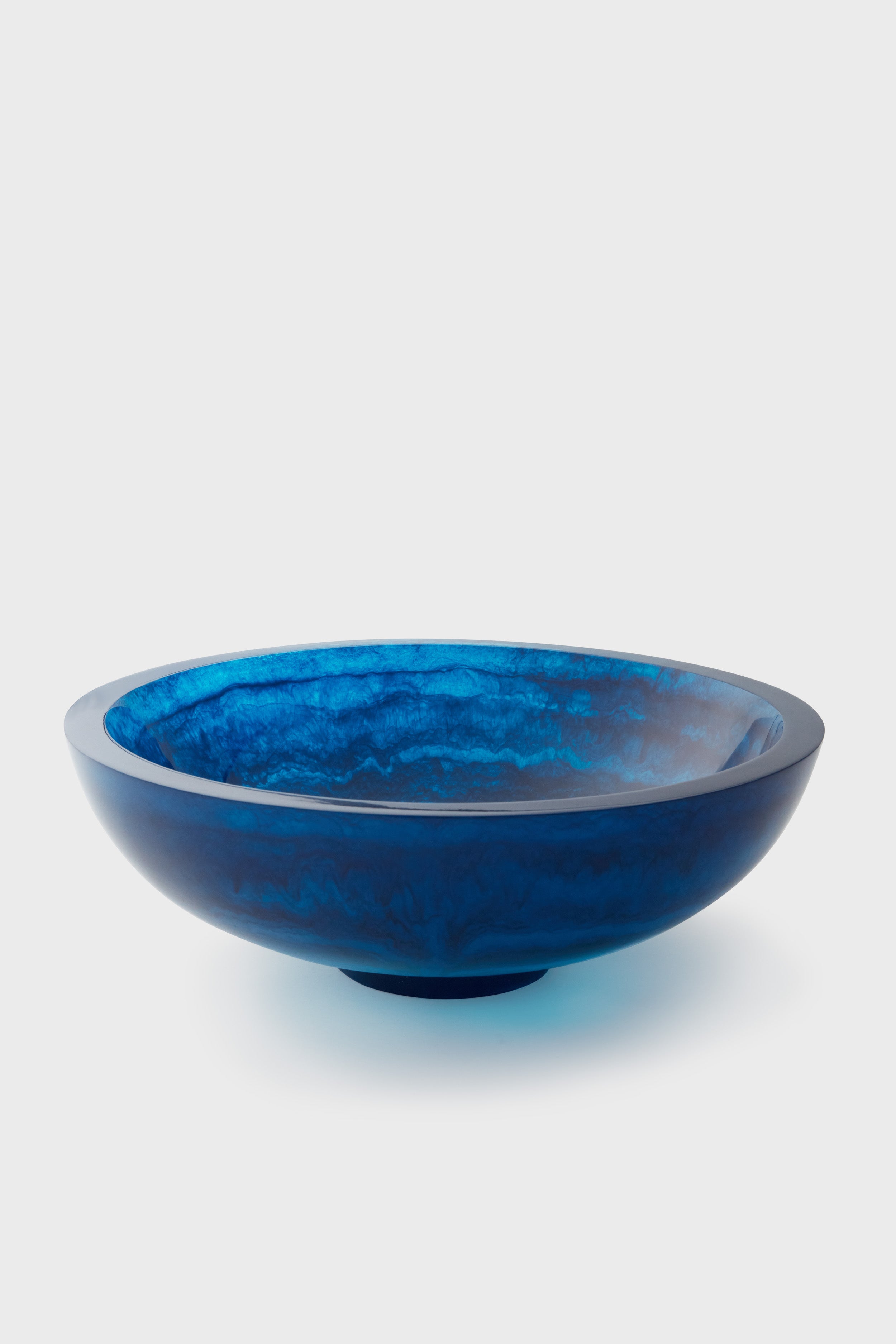 The Lily Juliet shallow round blue glass bowl features a handmade, smooth, and glossy surface—perfect as a food-safe decorative dish.