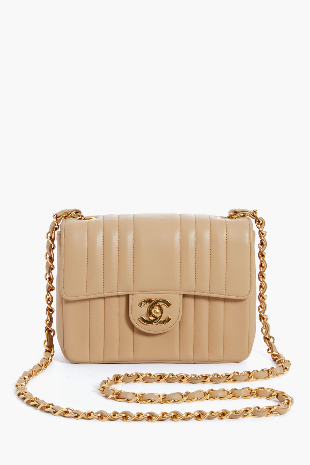 A beige quilted leather Tuckernuck Archive Collection bag with a gold chain strap and turn-lock closure, featuring classic elegance.
