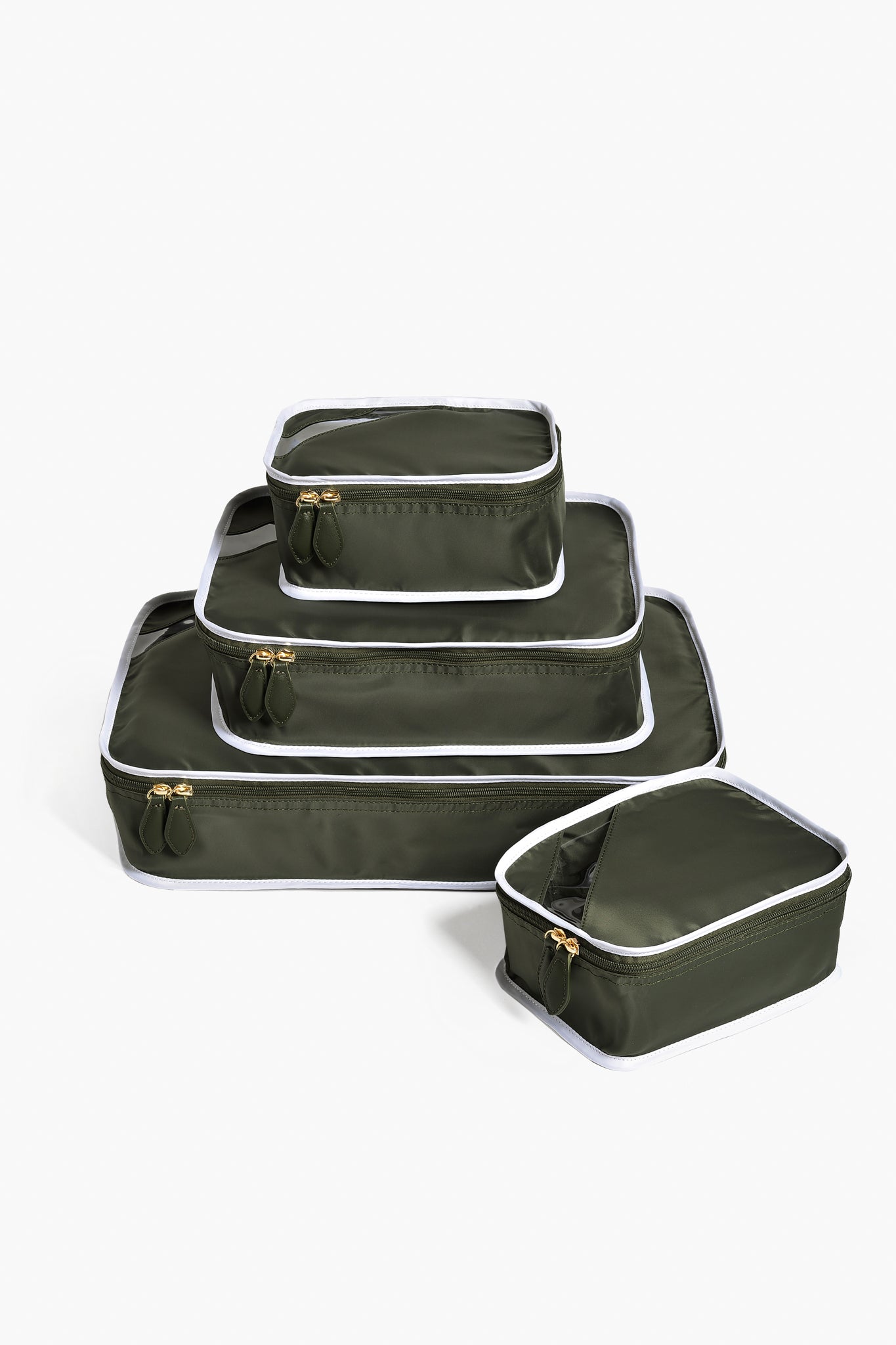 Paravel’s set of four olive green packing cubes with white trim and gold zippers keeps your travel essentials organized and adds style to your sustainable luggage collection.