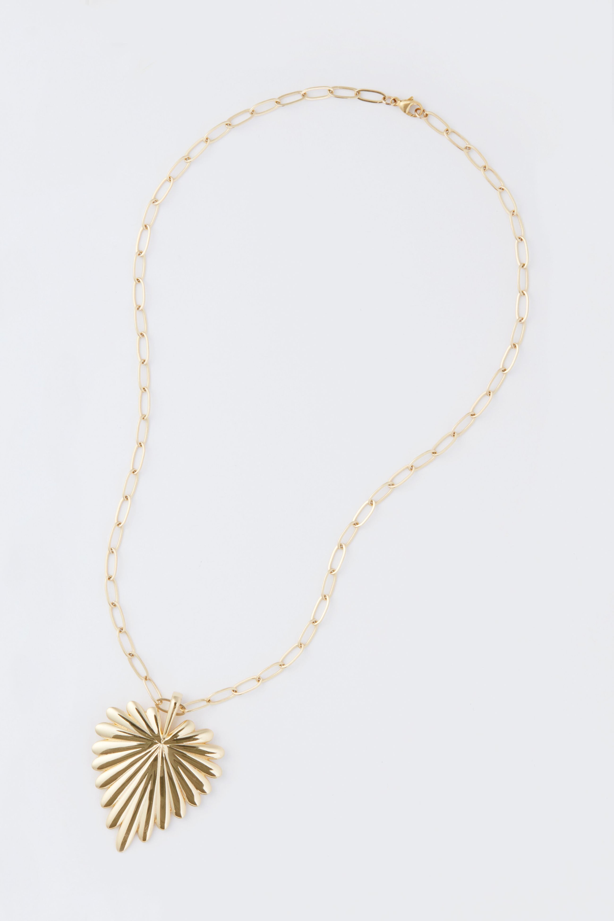 Jane Win gold necklace featuring a large, fan-shaped pendant inspired by a palm leaf heart, crafted in sterling silver with 14k gold plating.