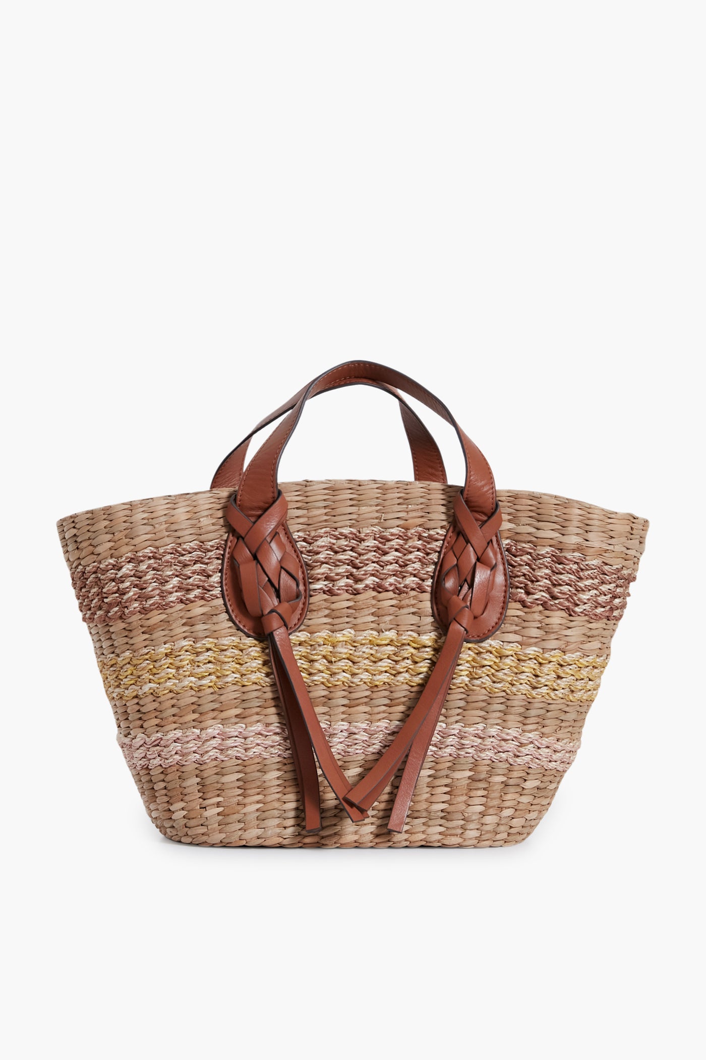 The Ulla Johnson woven straw tote features brown and beige horizontal stripes, brown leather handles, and braided leather details—a stylish handwoven beach basket to carry your essentials.