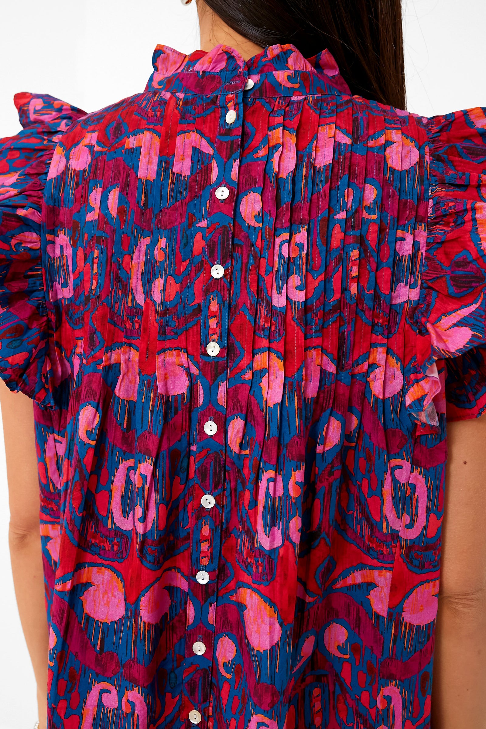 Exclusive Blue Kazak Pintuck Ruffle Top featuring a classic ruffled collar, effortless flutter sleeves, and fun button-down back. Perfect high-end piece for versatile styling.