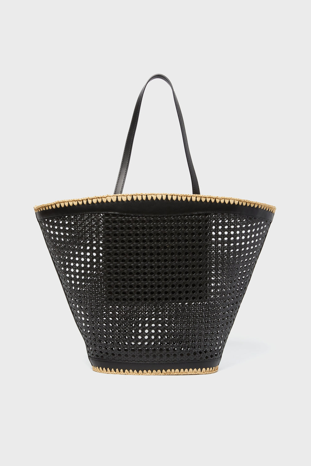 A black perforated BTB Ellie Tote with two handles and tan trim at the top and bottom—perfect for adding a boho-chic accent to any outfit.