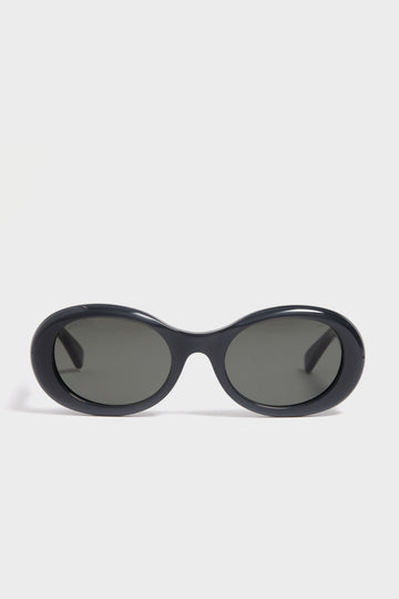 Gucci black oval sunglasses with dark lenses exude luxury fashion, offering a sleek alternative to classic styles.