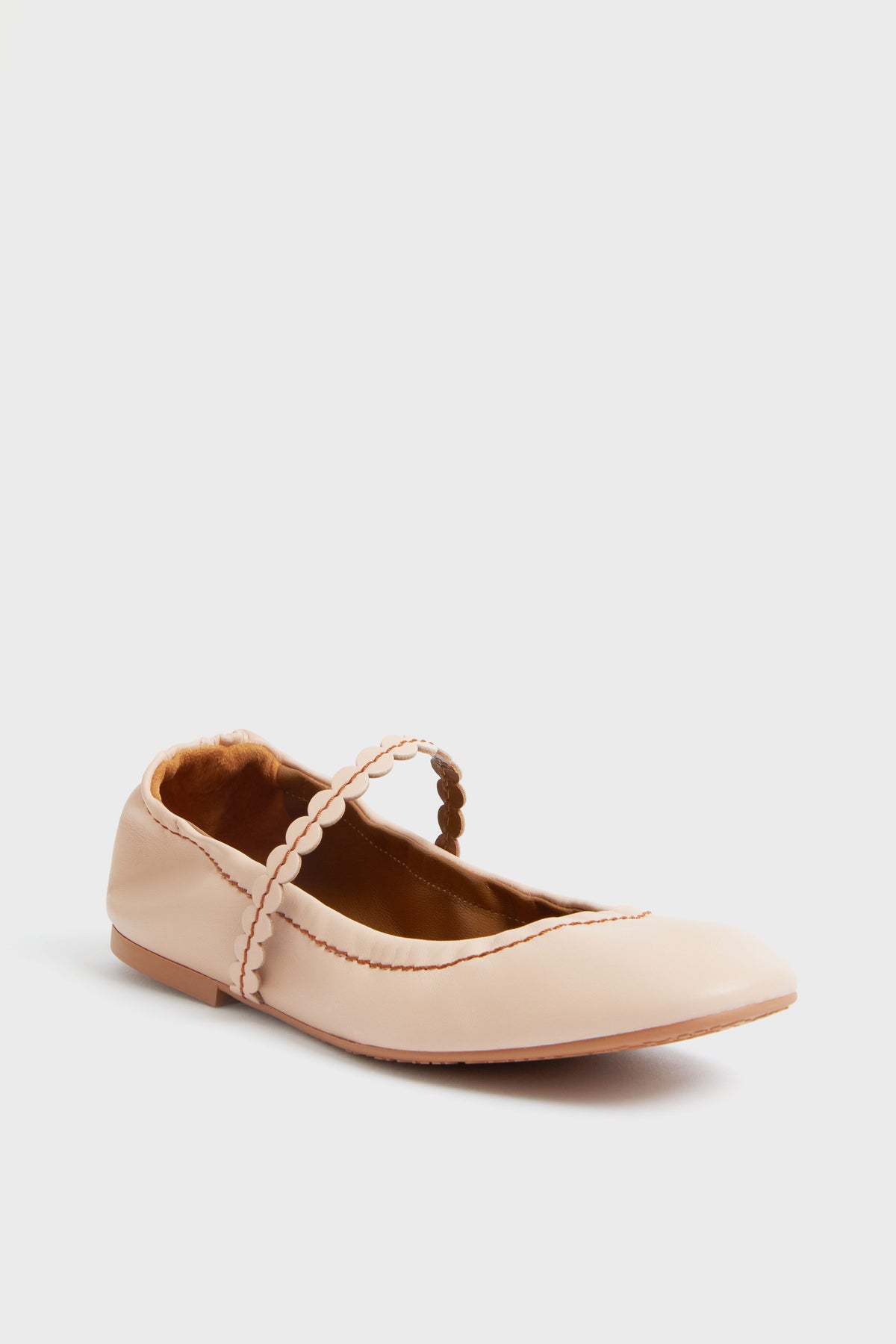 A single pale pink Mary Jane flat by See by Chloe, featuring a scalloped strap and trim in a slipper-inspired style.