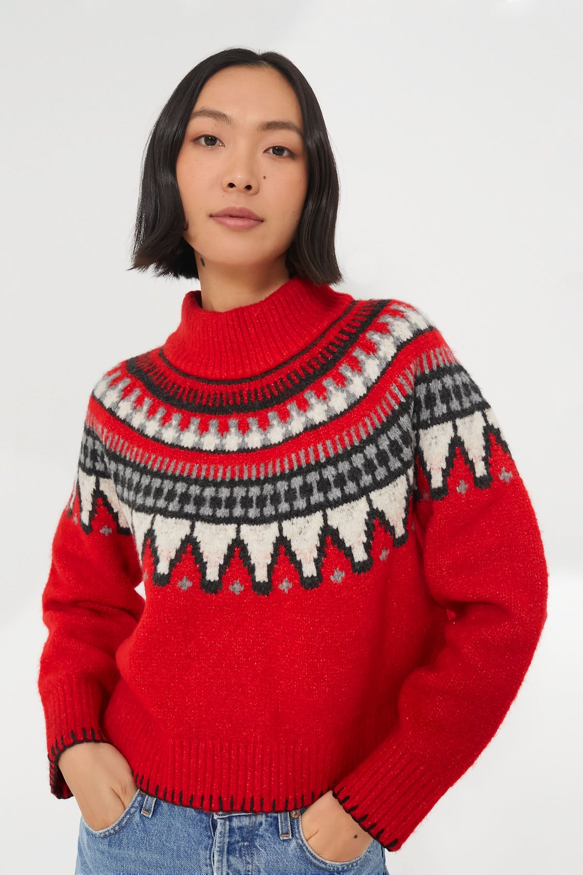 A woman in a cozy knit sweater, her vibrant Saylor Ceylona sweater adding a pop of color.