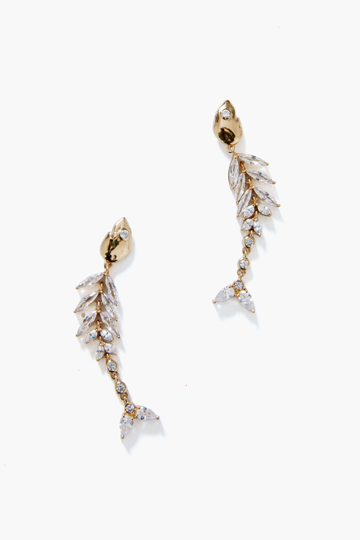 Mignonne Gavigan's 14K gold plated Elisabetta Fish Earrings feature a fish skeleton shape adorned with clear gemstones on the spine, fins, and tail—a unique jewelry piece that stands out.