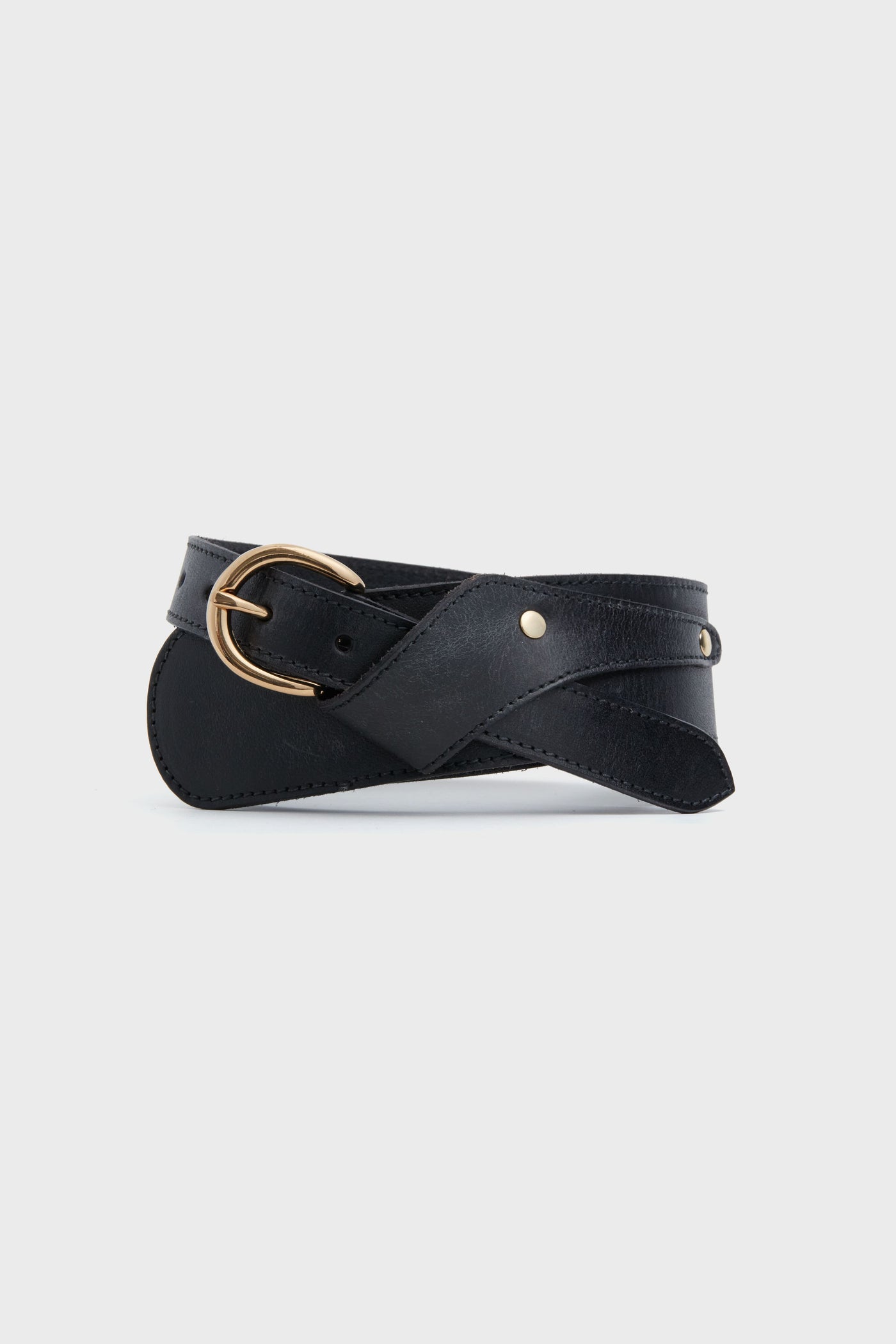 The Antik Batik black adjustable leather belt features a gold oval buckle and small metal rivet details, ideal for creating a figure-flattering look with boho dresses.