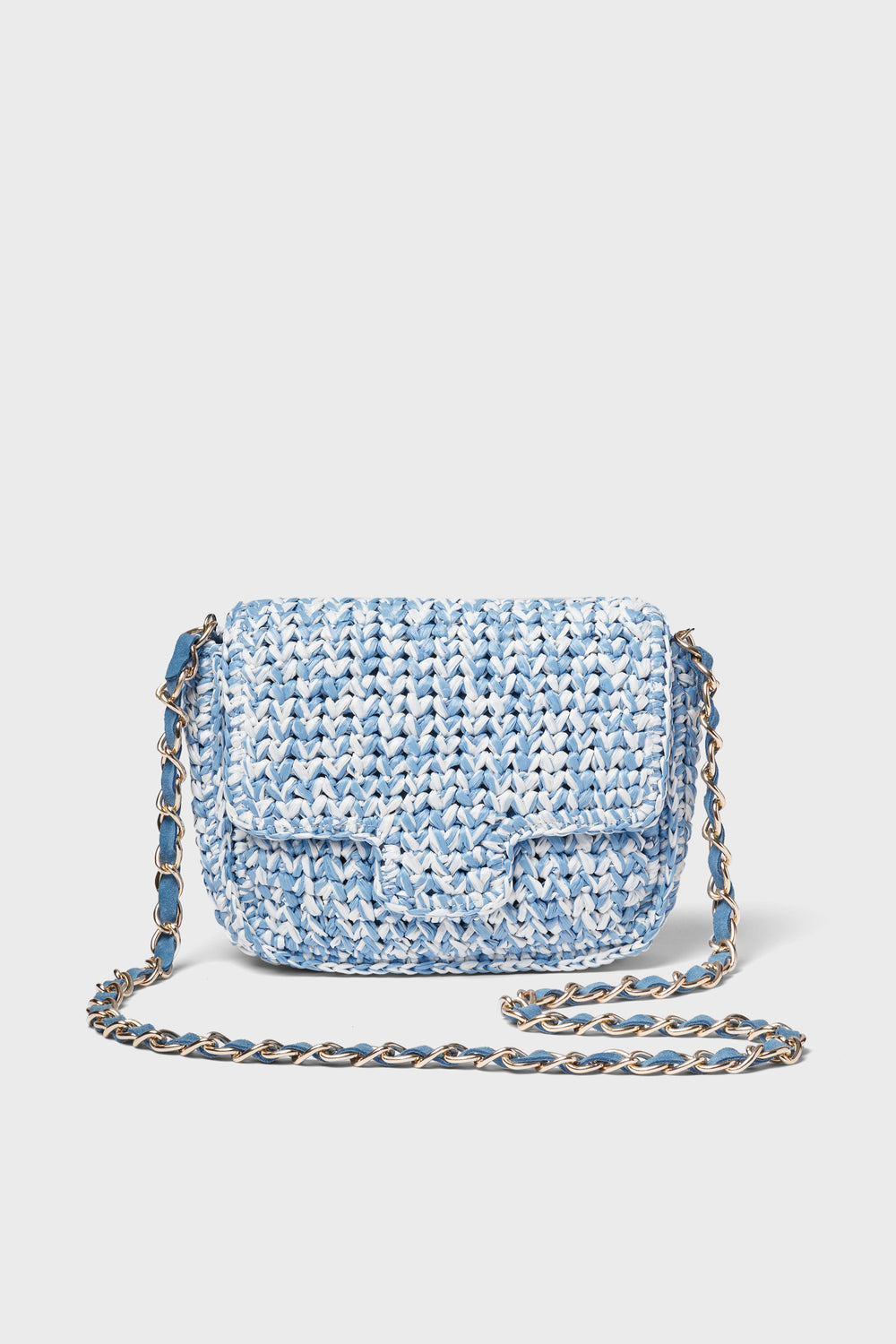 A small Italian crossbody bag by Caterina Bertini in blue and white, featuring a woven design, flap closure, and chain strap.