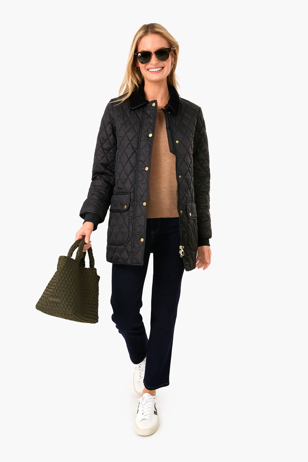 Woman wearing classic Black Kilmarie Quilt with diamond quilting, cord collar, and leather detailing, paired with a tote, showcasing an effortless, high-end, and fun style.