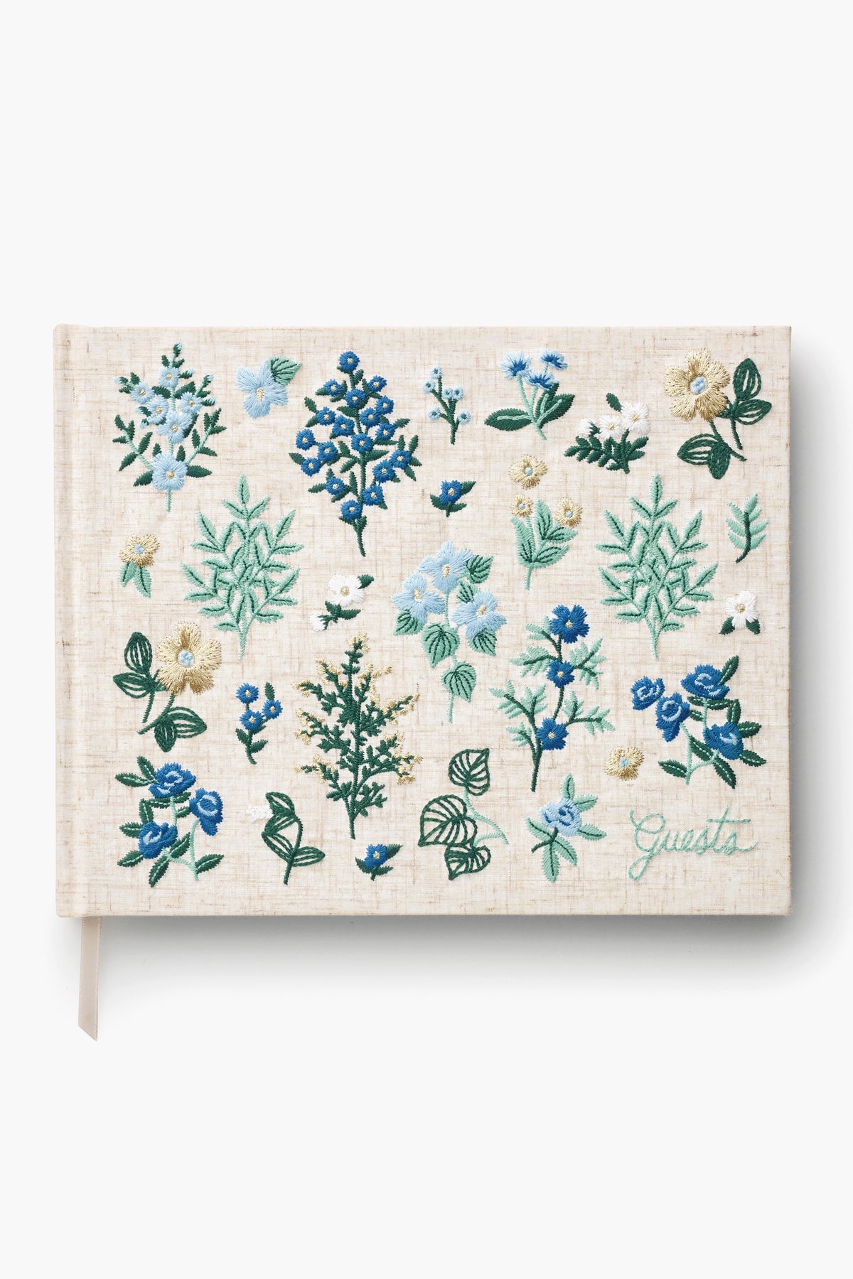 The Rifle Paper Co. beige hardcover guest book, titled "Guests," features green lettering and blue, green, and white floral embroidery—making it a charming keepsake for special occasions.
