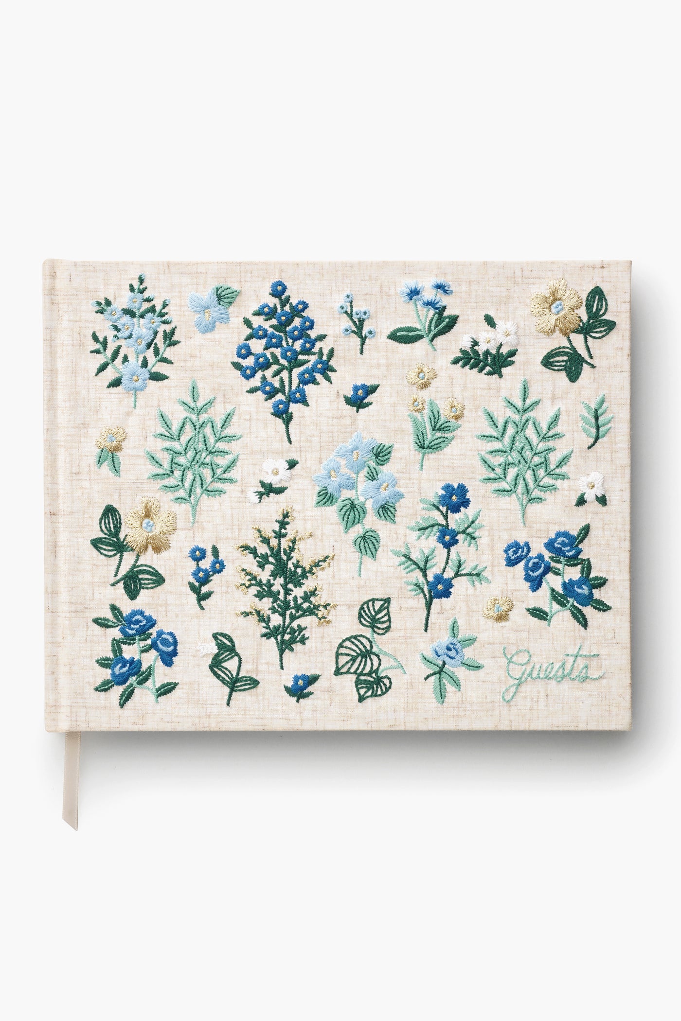 The Rifle Paper Co. beige hardcover guest book, titled "Guests," features green lettering and blue, green, and white floral embroidery—making it a charming keepsake for special occasions.