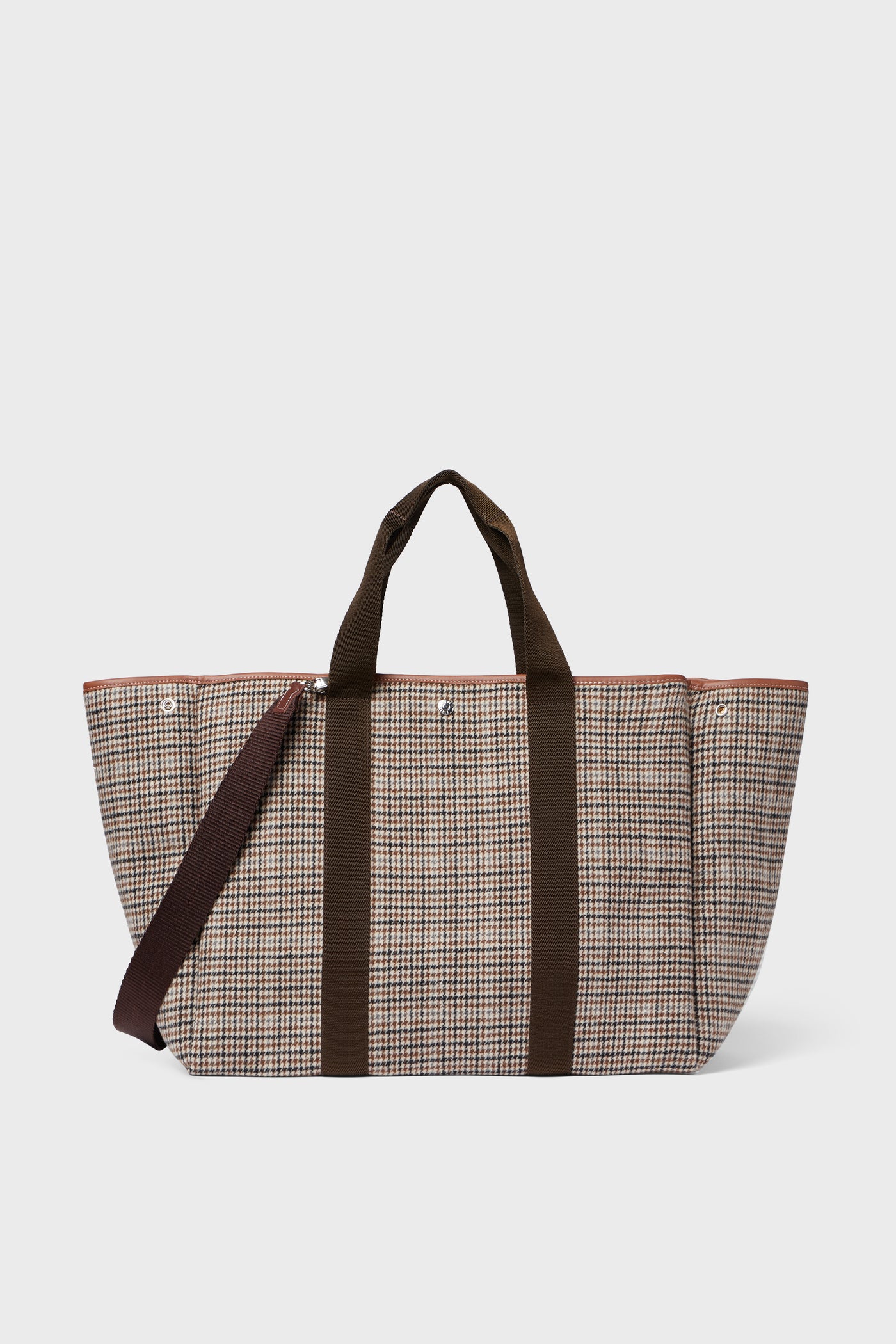 The Rue de Verneuil Camel Plaid Traversee large wool flannel tote features brown handles and a matching shoulder strap, making it ideal for luxurious luggage needs.