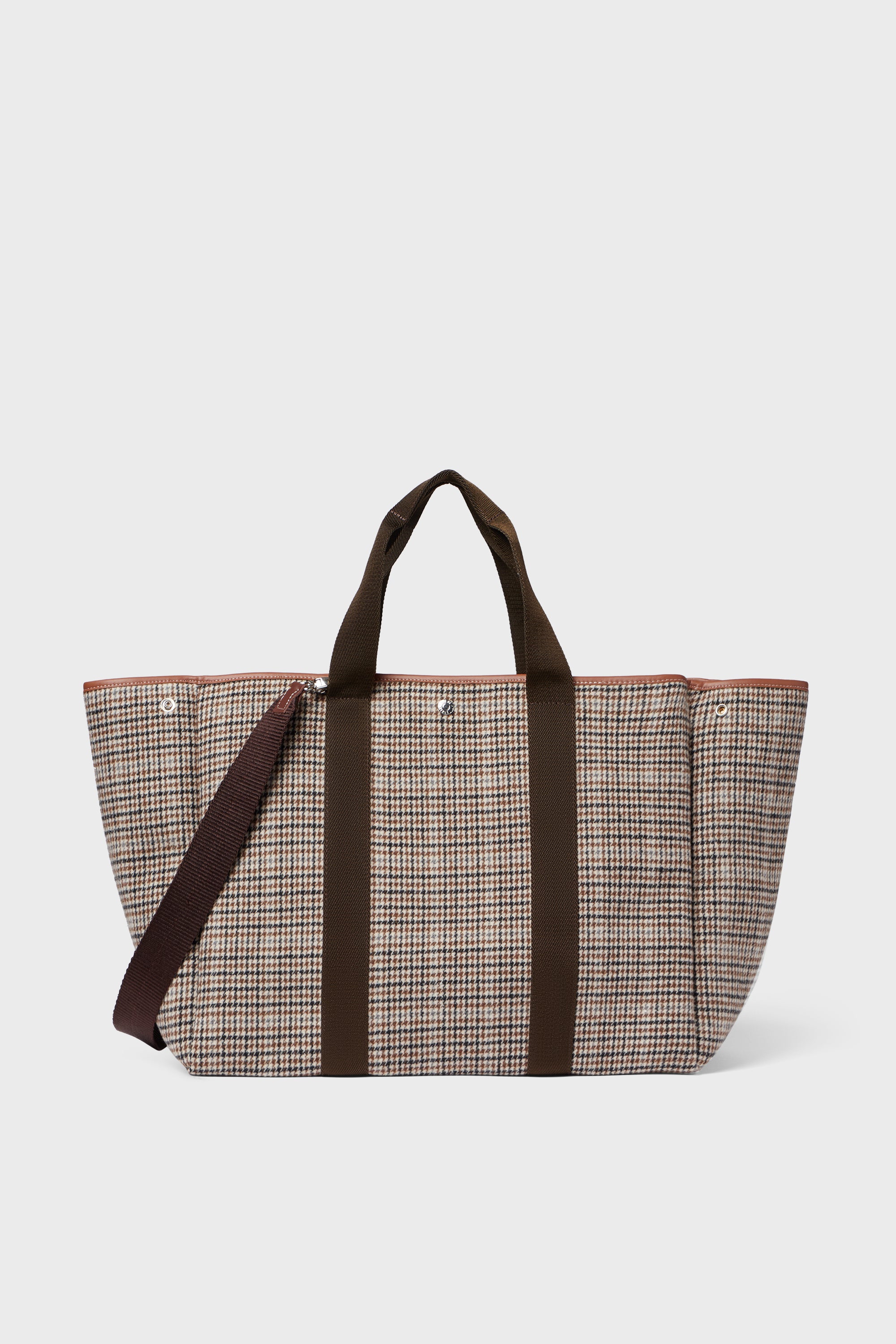 The Rue de Verneuil Camel Plaid Traversee large wool flannel tote features brown handles and a matching shoulder strap, making it ideal for luxurious luggage needs.
