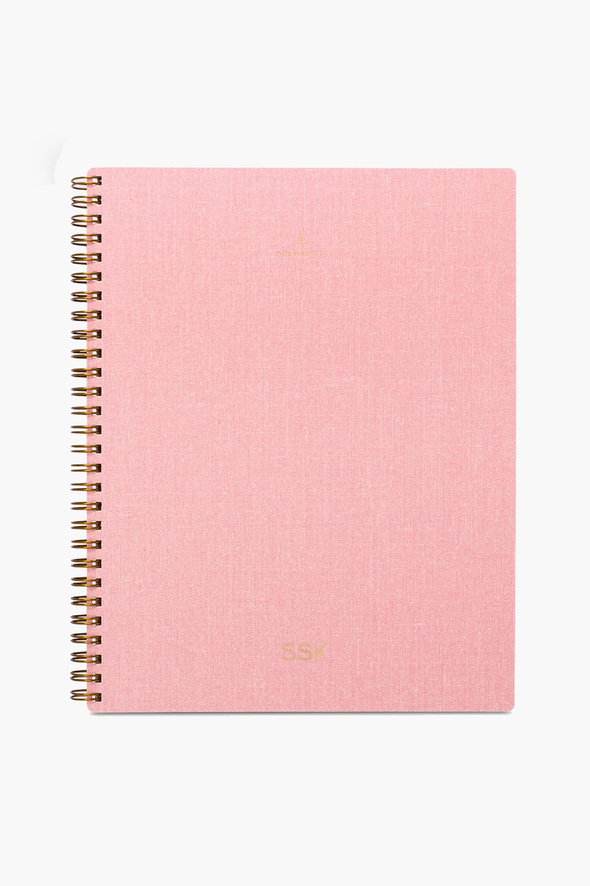 The APPOINTED Blossom Pink Lined Notebook features a textured book-cloth cover, gold lettering, spiral binding, and is crafted from recycled paper.