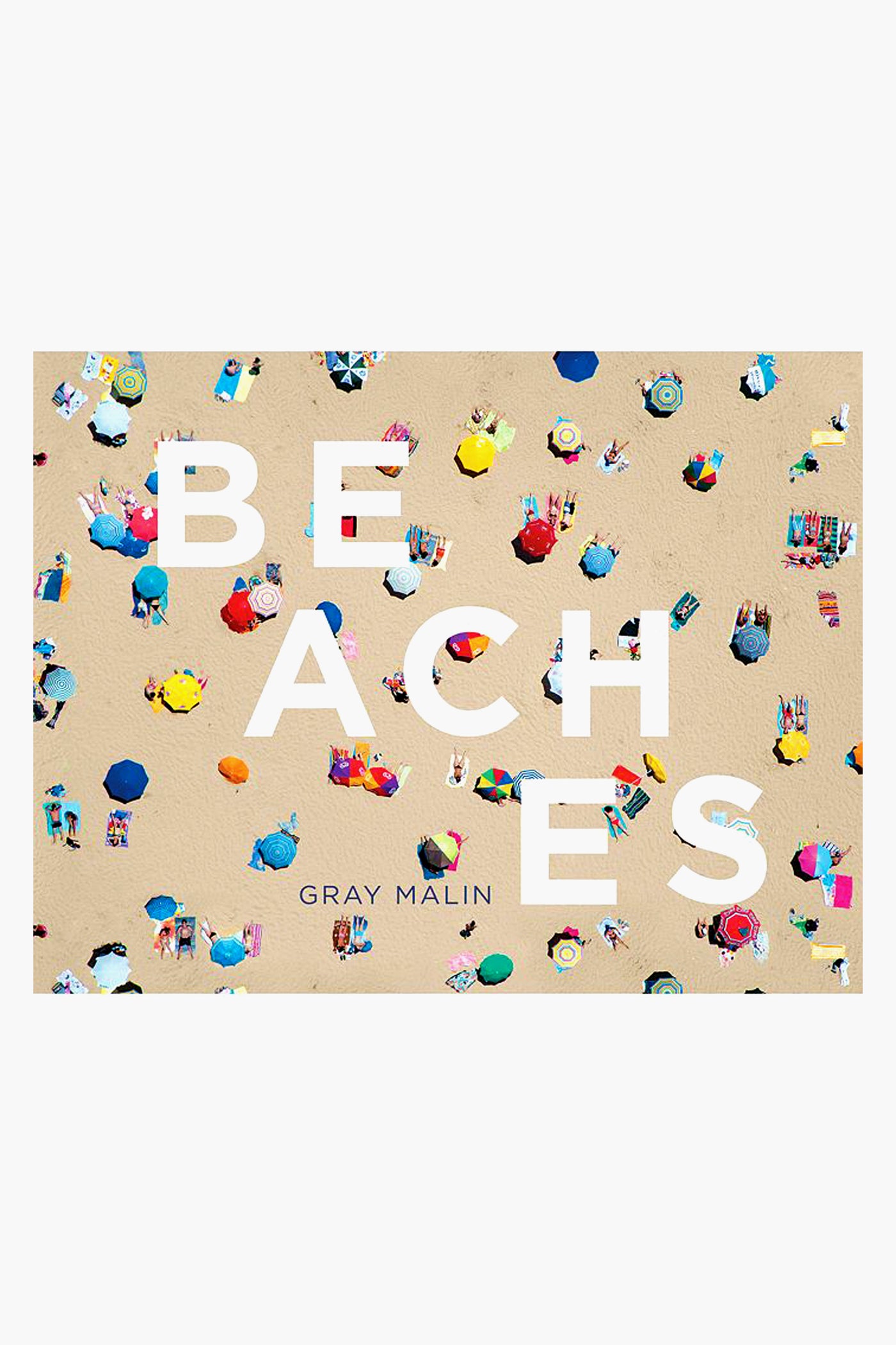 Aerial view of a crowded sandy beach with colorful umbrellas and towels, overlaid with large white text reading BEACHES and Gray Malin's name below—an eye-catching Rizzoli coffee table book featuring stunning aerial beach photography.