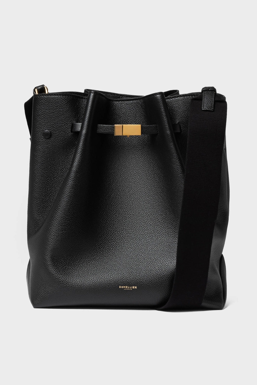 A black leather hobo bag by Demellier, featuring a wide shoulder strap, gold-tone hardware, and discreet branding near the bottom—an elegant addition to any collection of handcrafted handbags.