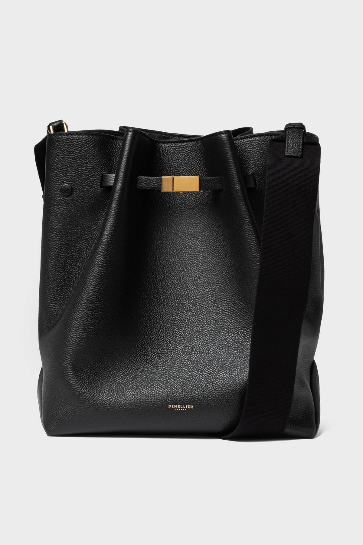A black leather hobo bag by Demellier, featuring a wide shoulder strap, gold-tone hardware, and discreet branding near the bottom—an elegant addition to any collection of handcrafted handbags.