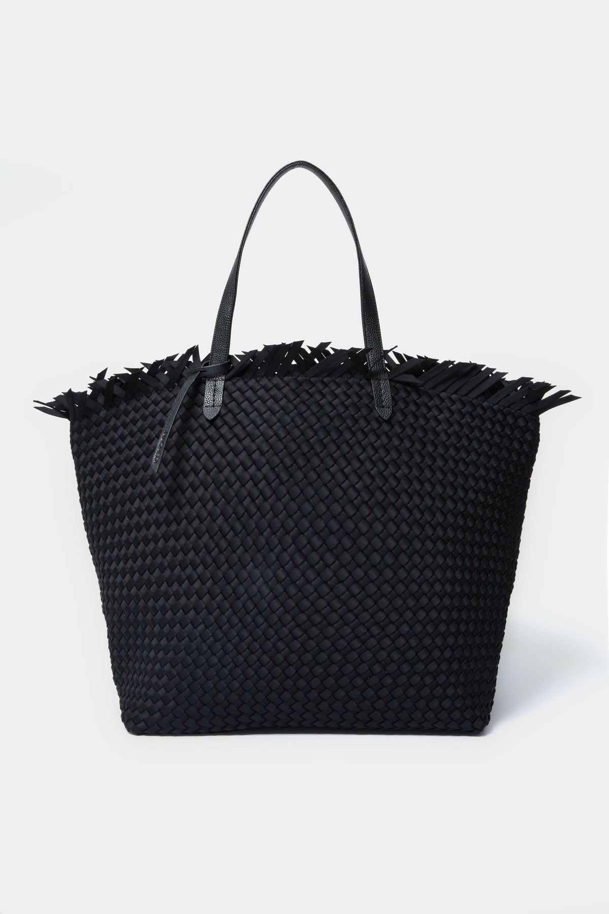 A large black handwoven neoprene tote bag by Naghedi, featuring vegan leather handles and fringe detailing along the top edge.