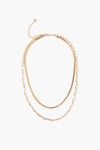 Alexa Leigh Double Down Layering Necklace features a flat herringbone chain and an elongated link chain, crafted in 18k gold plating with an adjustable clasp.