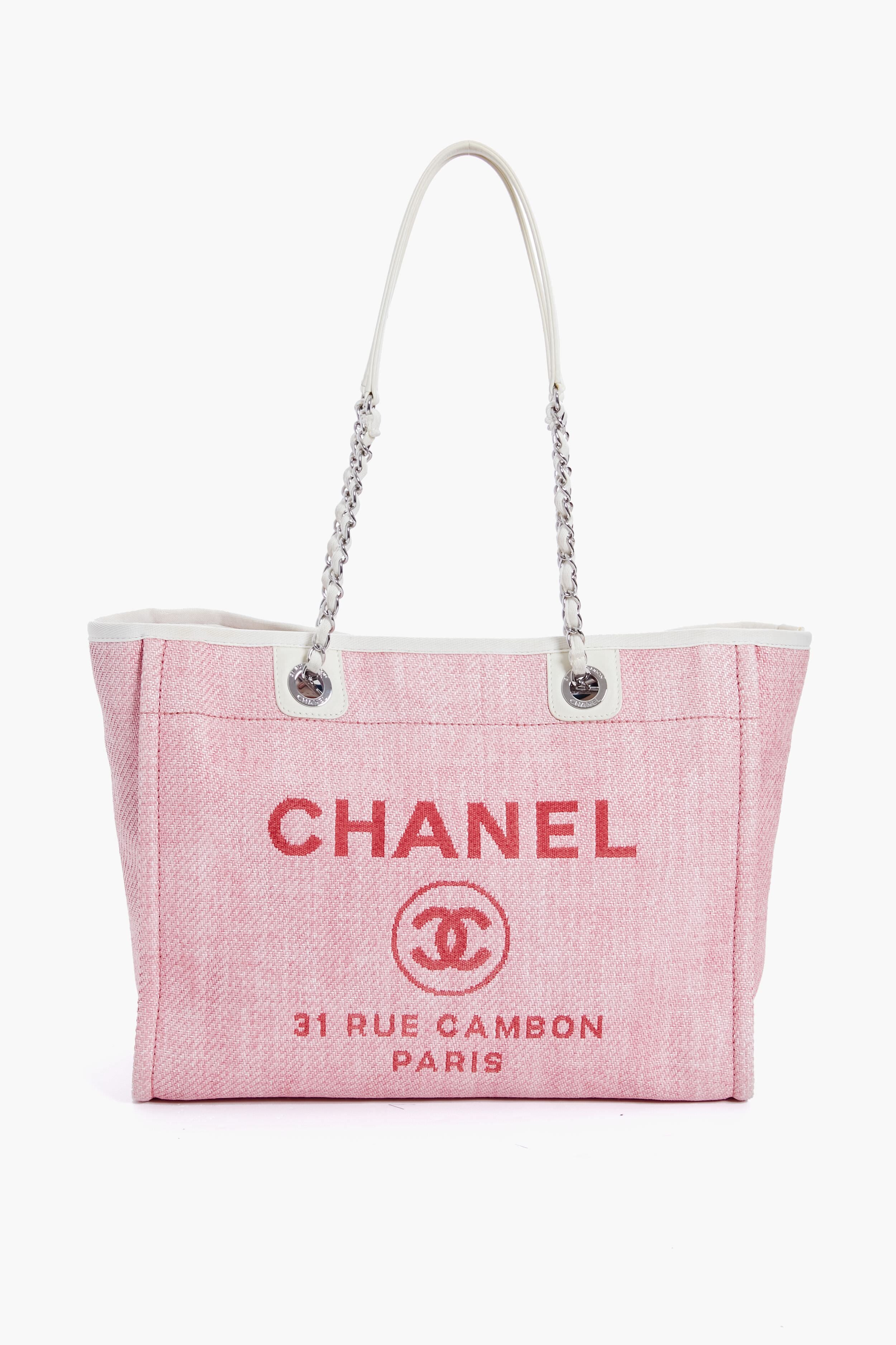 A pink Tuckernuck Archive Collection tote with white handles, featuring the brand logo and classic text on the front.