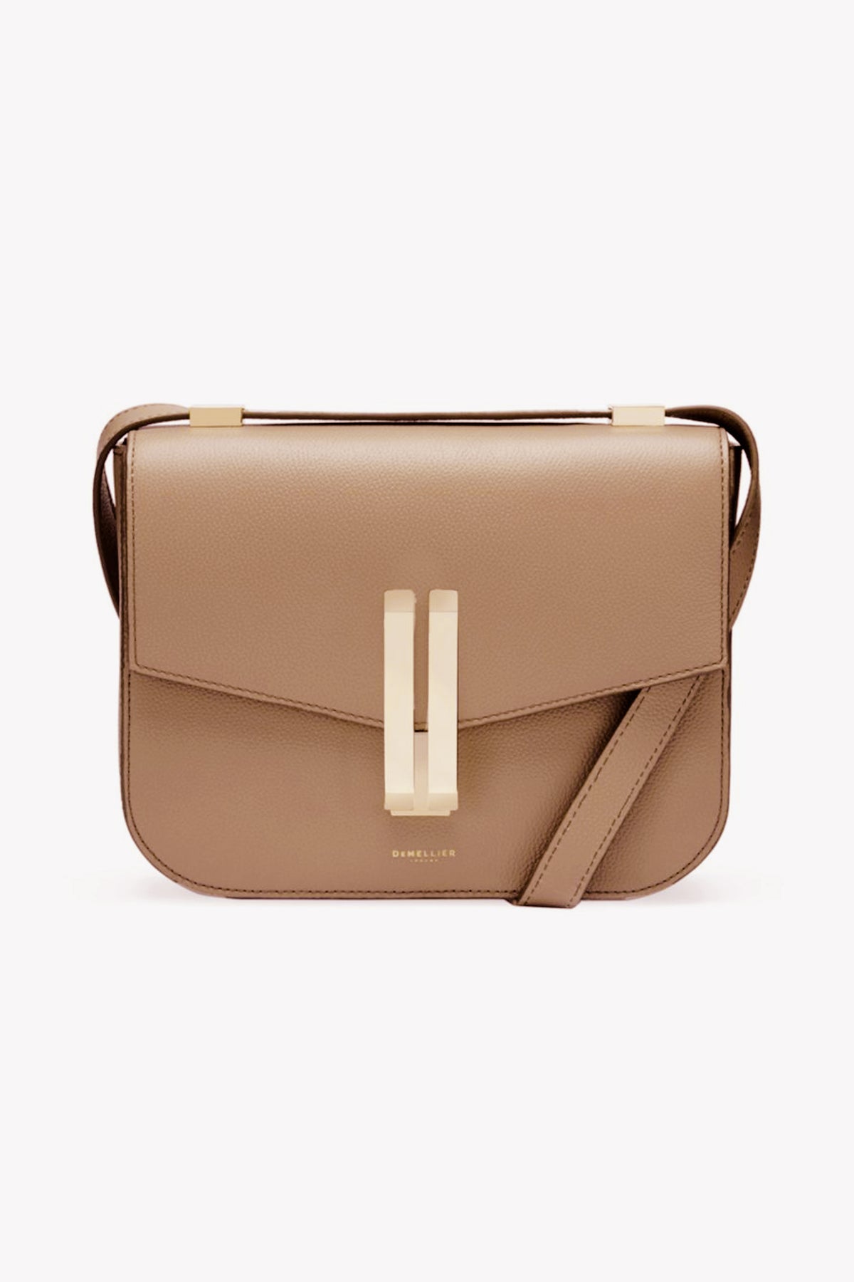 The Demellier beige cowhide leather crossbody bag features a structured rectangular shape, gold-tone hardware, and a front flap closure.