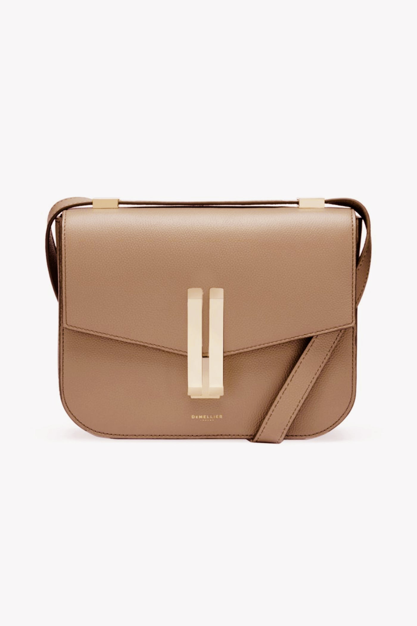 The Demellier beige cowhide leather crossbody bag features a structured rectangular shape, gold-tone hardware, and a front flap closure.