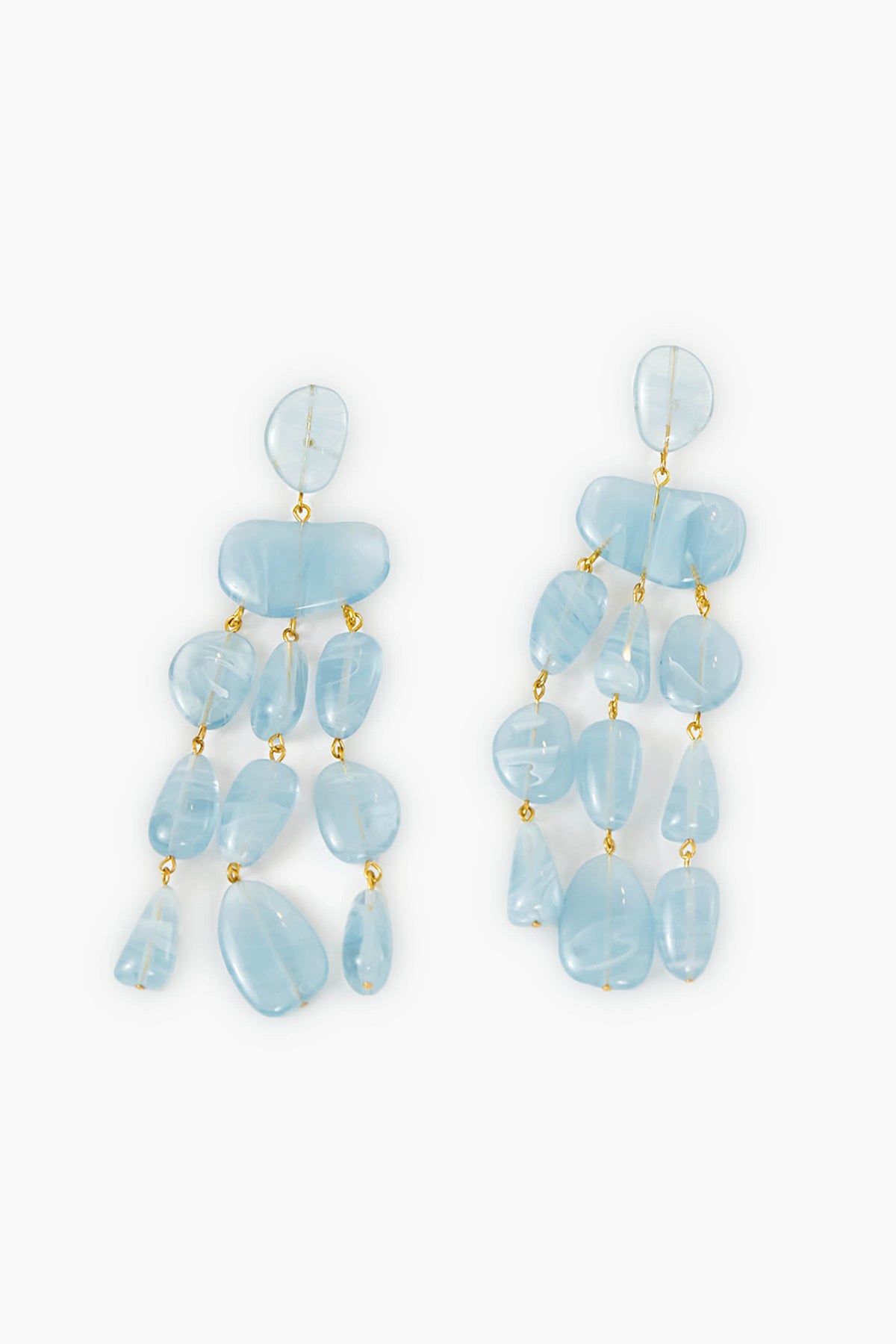 Cult Gaia Ice Blue Tallulah Earrings feature dangling, irregular-shaped light blue resin pebbles linked by small gold connectors, creating a striking statement accessory.