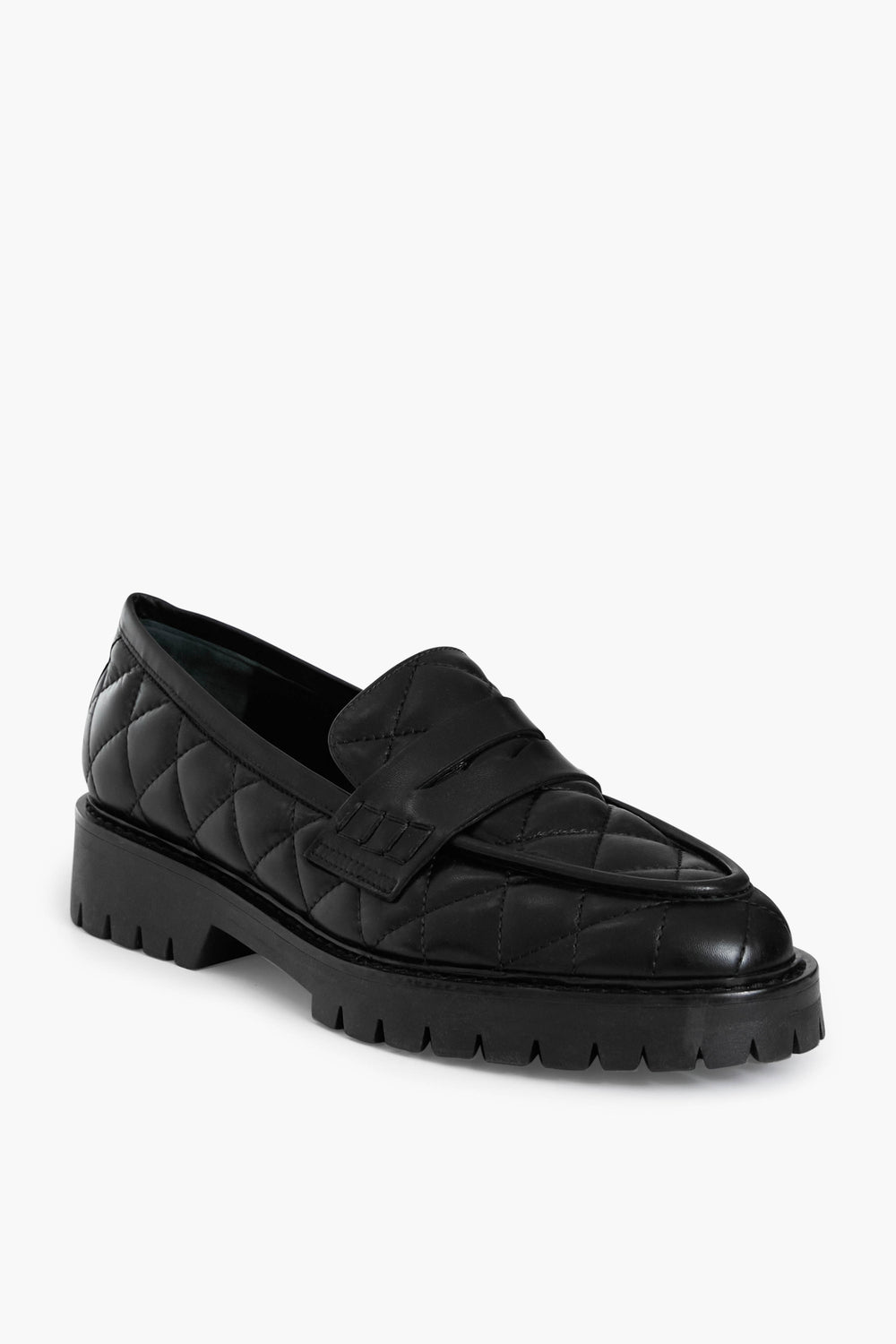Flattered’s Black Signe Loafers in quilted leather feature a chunky sole and a decorative strap, blending handmade elegance with contemporary style.