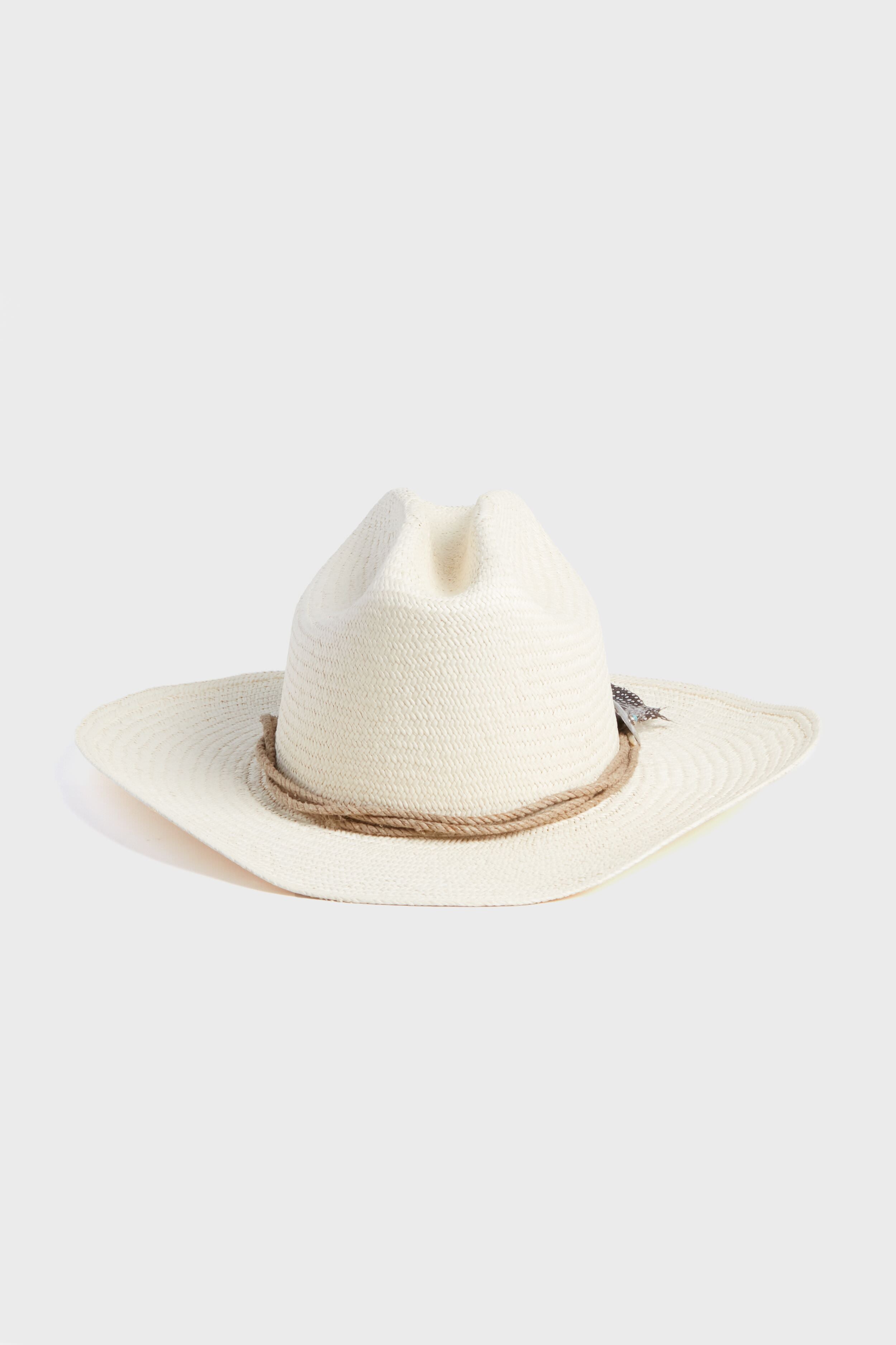 A cream-colored, wide-brimmed Toquilla straw cowboy hat from Hampui Hats features a brown rope band—an ideal custom-made, sustainable choice.