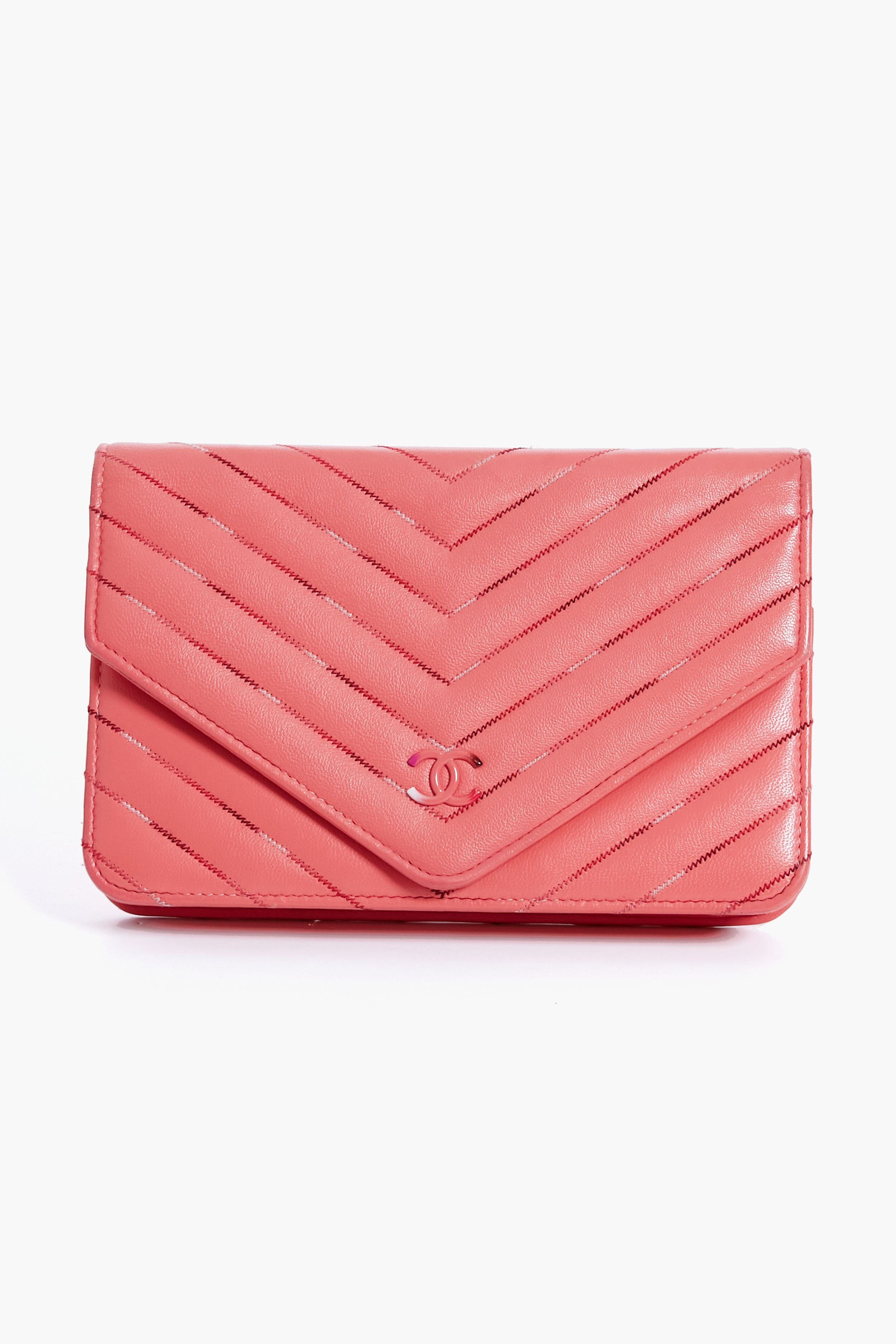 A Tuckernuck Archive Collection Wallet on Chain in pink gradient chevron quilted leather, featuring a small metallic logo on the front flap.