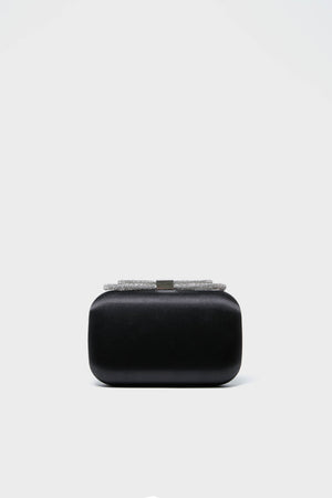 The Olga Berg Black Ada Crystal Bow Clutch is a rectangular black evening bag with a crystal-embellished, silver-toned clasp—combining sophistication and elegance for any occasion.