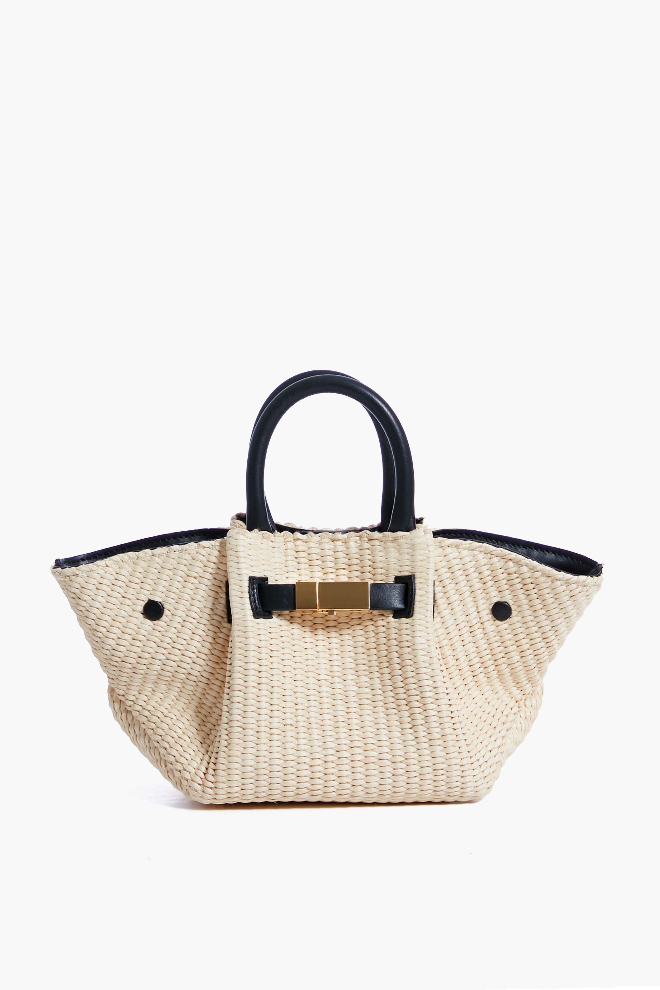The Demellier woven raffia handbag in beige features black handles and a gold accent, making it a perfect luxury women's purse.
