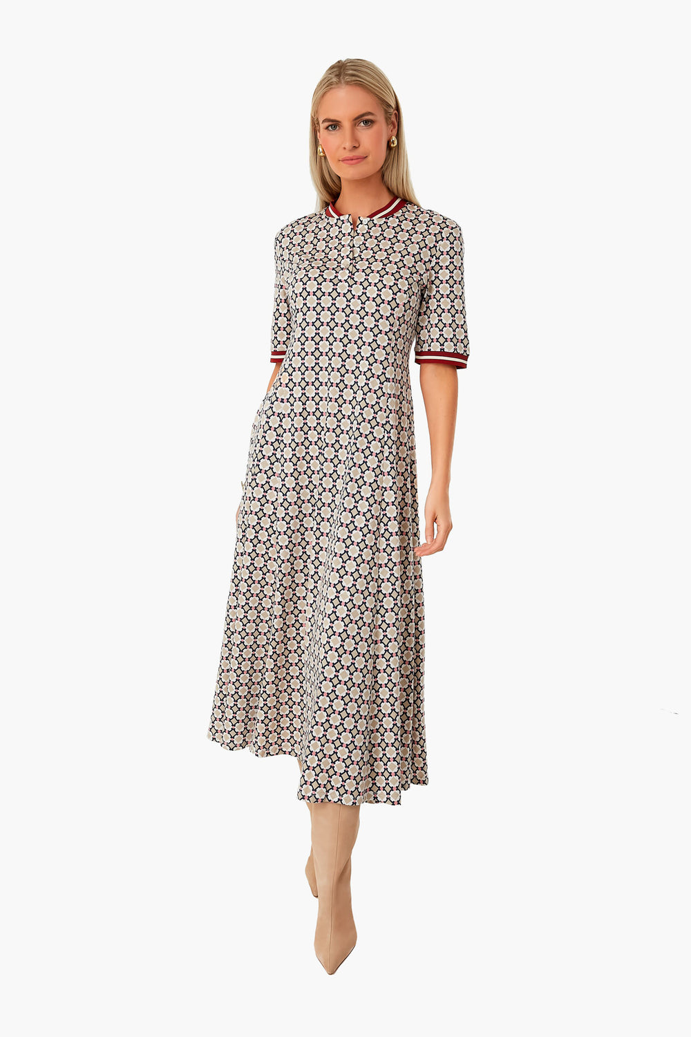 A woman wears the stylish Ivory Adesso Dress by Weekend Max Mara, a multicolor midi with red accents on the collar and cuffs, paired with beige heels.